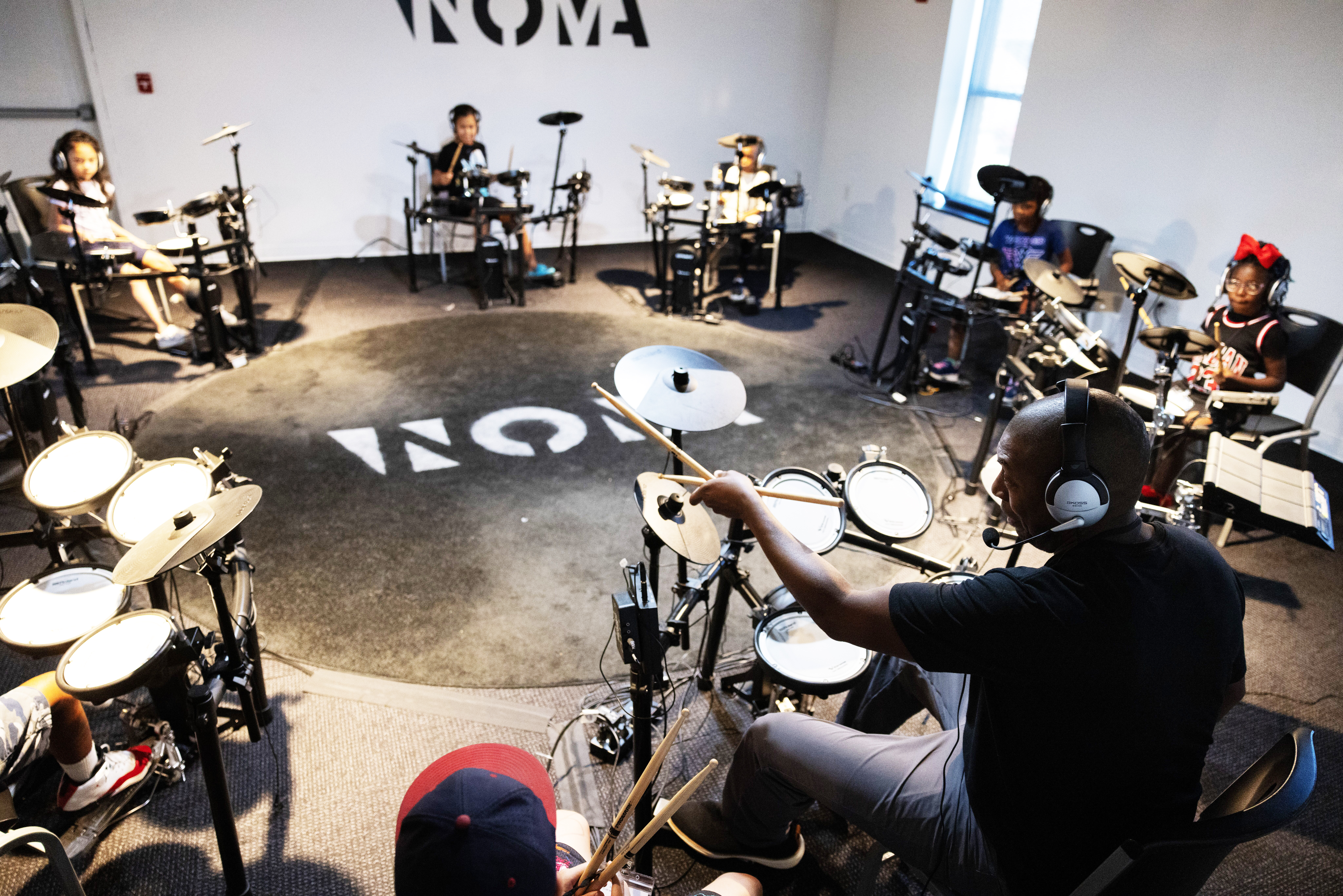Dana Murray, executive director of North Omaha Music &amp; Arts, teaches drums during a summer camp. The academy offers group classes in bass, drums, piano and dance.<br />(Rebecca S. Gratz / Flatwater Free Press)