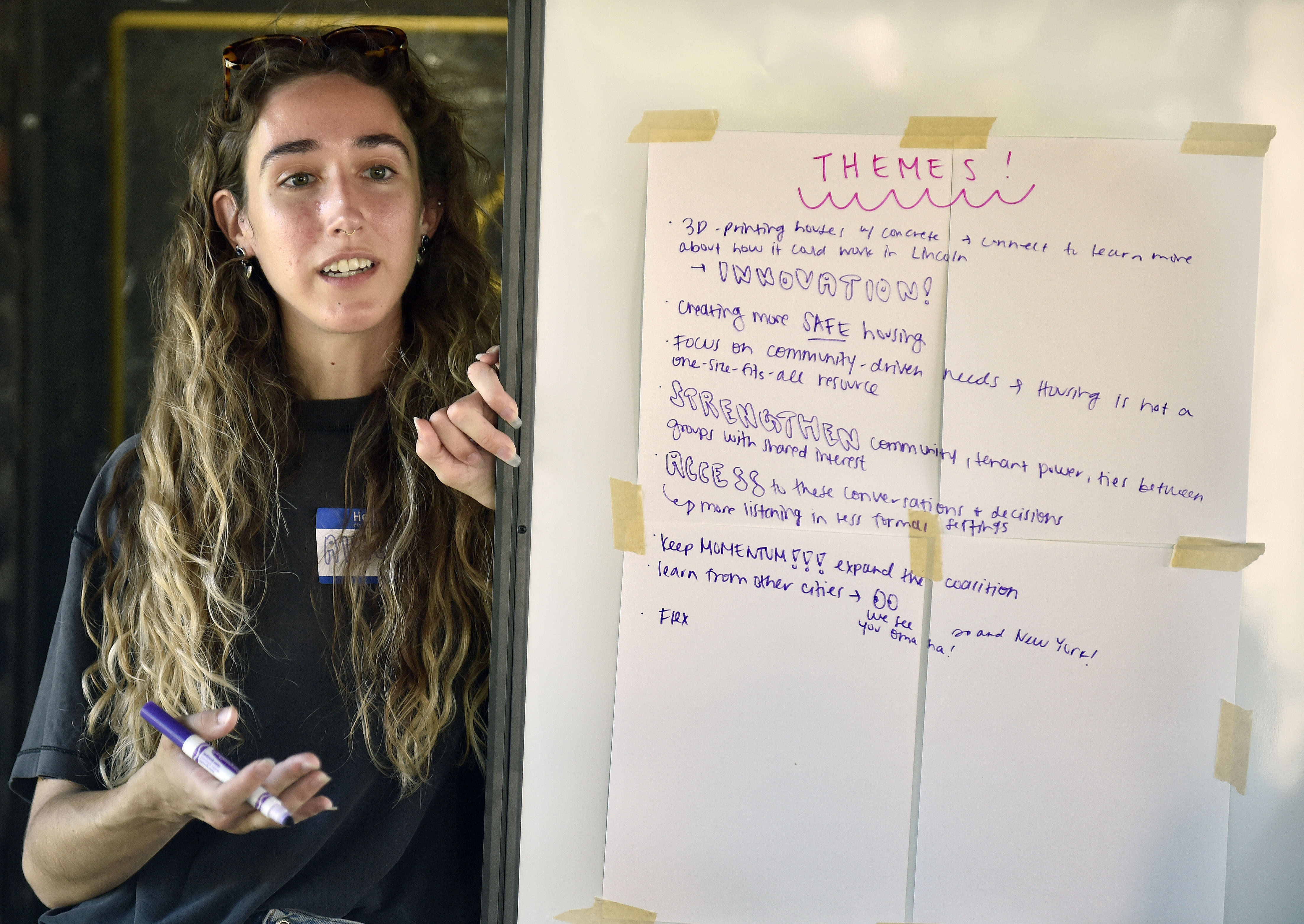 Allie Christianson, a community organizer with Civic Nebraska, takes notes on a discussion about the prospects of Lincoln’s voter-approved ban on housing discrimination based on someone’s source of income.<br />(Eric Gregory / Flatwater Free Press)