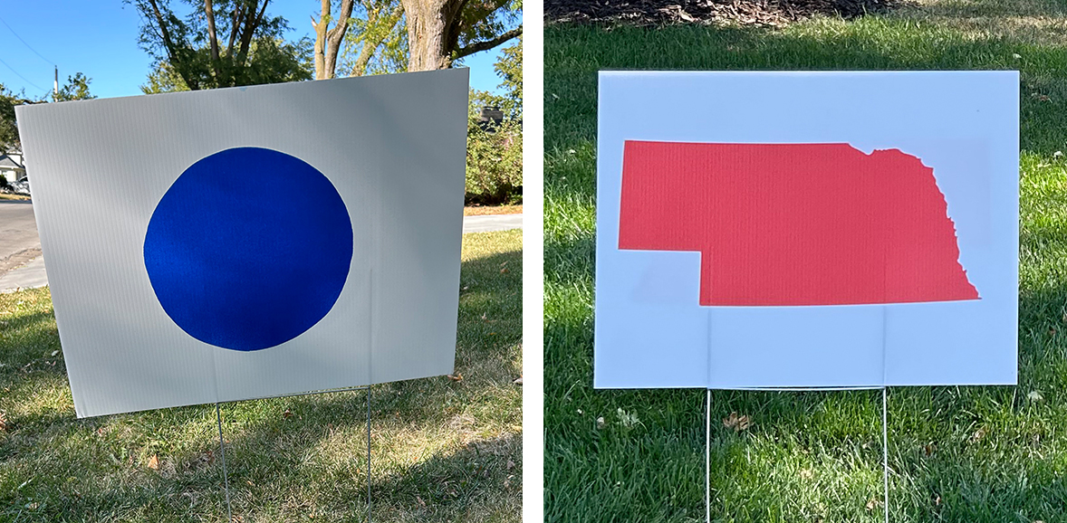Blue dot signs and red state signs were popping up in the Omaha-based 2nd Congressional District last election cycle, sometimes with both signs dueling in neighboring yards.<br />(Cate Folsom / Nebraska Examiner)