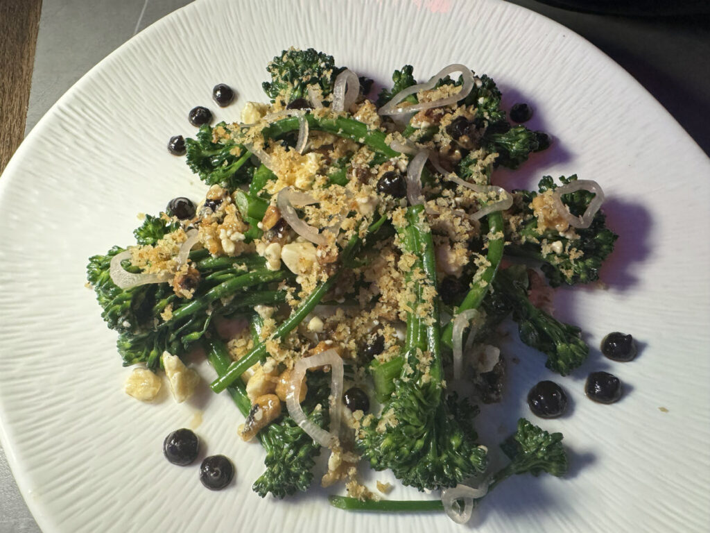 Crisp and cool, the broccolini salad featured gorgonzola, candied walnuts, pickled shallots, broccolini and seasoned bread crumbs topped with a persimmon red wine coulis.<br />(Sarah Baker Hansen / Flatwater Free Press)