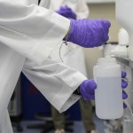 Logan Feeney pours a water sample with forever chemicals, known as PFAS, into a container for research, April 10, 2024, at a U.S. Environmental Protection Agency lab in Cincinnati.
 (Joshua A. Bickel / AP Photo)