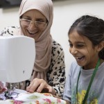 Amal Alalim helps a student in a sewing class at Olive Community Services, Tuesday, July 29, 2025, in Fullerton, Calif. The class was part of the organization's Intergenerational Summer Camp. 
(Zoë Meyers / AP Photo)