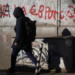 A woman passes by a graffiti reading "No to the euro" altered to "Yes to the euro" in Sofia, Monday, Dec. 29, 2025. 
(Valentina Petrova / AP Photo)