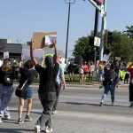 Protesters wave signs and chant near 33rd and L Streets in Omaha on Tuesday after a raid of an Omaha-area food plant. 
(Cindy Gonzalez / Nebraska Examiner)