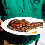 The bone-in ribeye at 801 Chophouse, served to you by a waiter in a crisp green jacket. 
(Joshua Foo / Flatwater Free Press)
