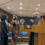Tamara T. Mosby being sworn in by the Honorable Derek Vaughn. Her daughter Brooklyn (left) had the best seat in the house. 
(Courtesy of Dr. Montegut)