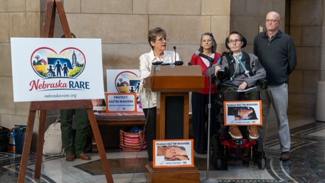 Susan Samuelson (center) leads a rally with Tammy, Derek and Darin Caster, (from left) in the Nebraska State Capitol urging the Nebraska Department of Health and Human Services not to make significant changes to the state’s Aged and Disabled Waiver and Traumatic Brain Injury Waiver, Jan. 14, 2026. (Zach Wendling / Nebraska Examiner)