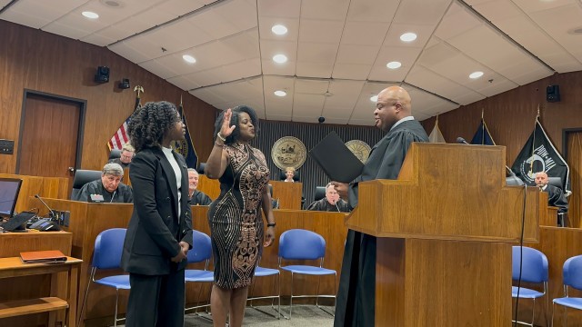 Tamara T. Mosby being sworn in by the Honorable Derek Vaughn. Her daughter Brooklyn (left) had the best seat in the house. 
(Courtesy of Dr. Montegut)
