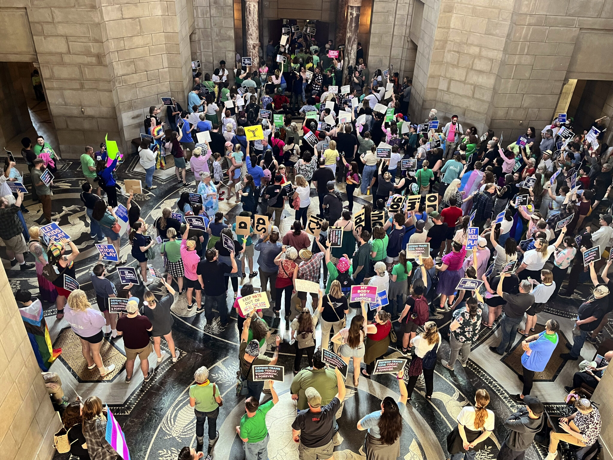 Hundreds of people descend on the Nebraska Capitol in Lincoln on May 16, 2023, to protest plans by conservative lawmakers to revive a failed abortion ban by folding it into a bill that would ban gender-affirming care in transgender minors. The bill ultimately passed.<br />(Margery Beck / AP Photo)