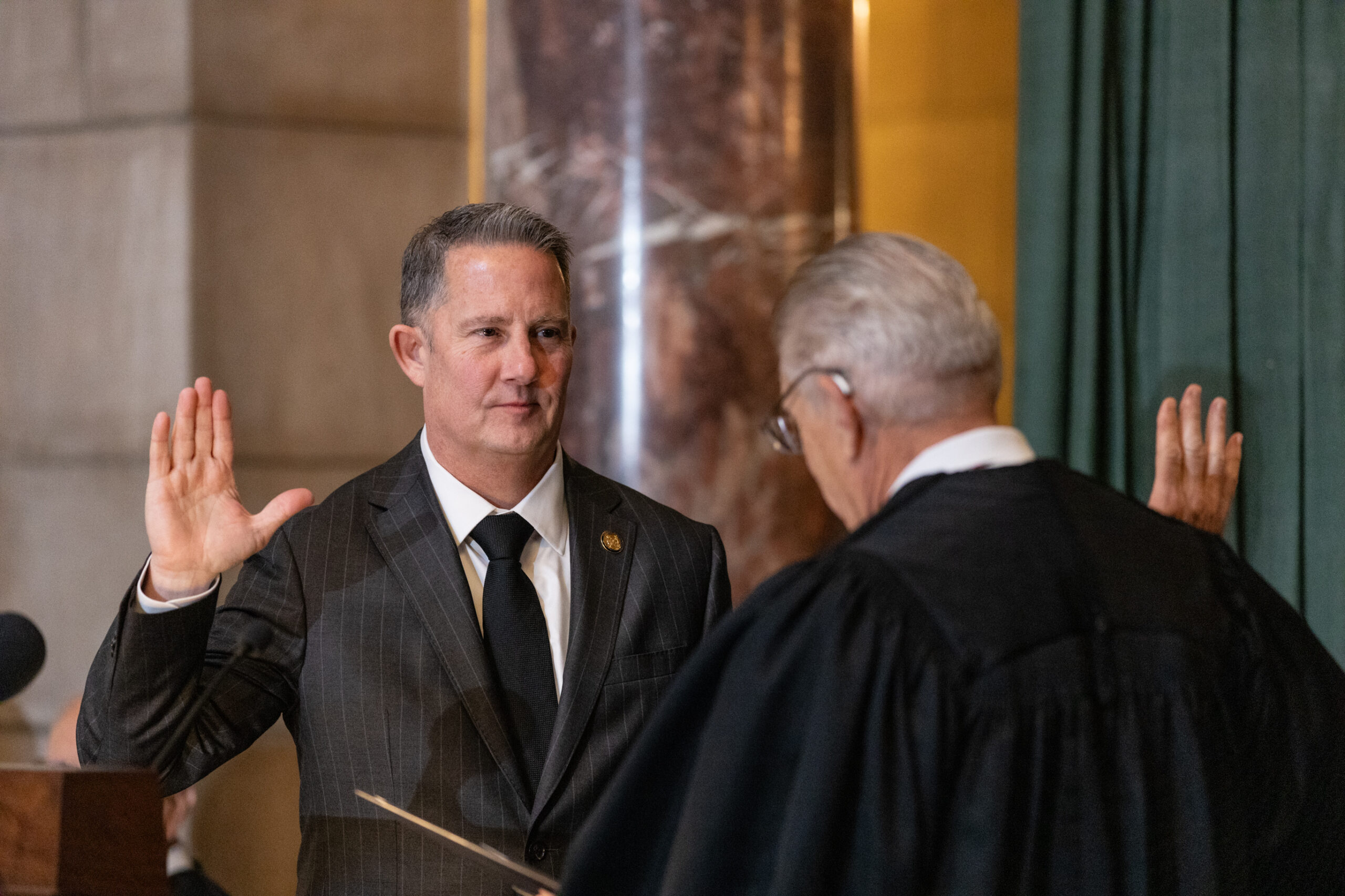 Nebraska Supreme Court Chief Justice Jeffrey Funke (left) takes an oath of office from his predecessor, retired Chief Justice Mike Heavican, during Funke’s formal investiture ceremony, Nov. 22, 2024.<br />(Photo courtesy of Nebraska Judicial Branch)