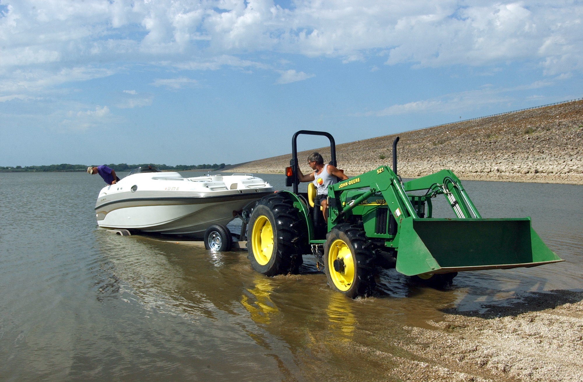 Tower Harbor Marina owner Bill Barrow uses a tractor on a newly made rock boat ramp to lower Doug Vollmers boat Thursday afternoon, Aug. 31, 2006, into Kanopolis Reservoir in Kanopolis, Kan.<br />(Sandra J. Milburn / The Hutchinson News via AP )