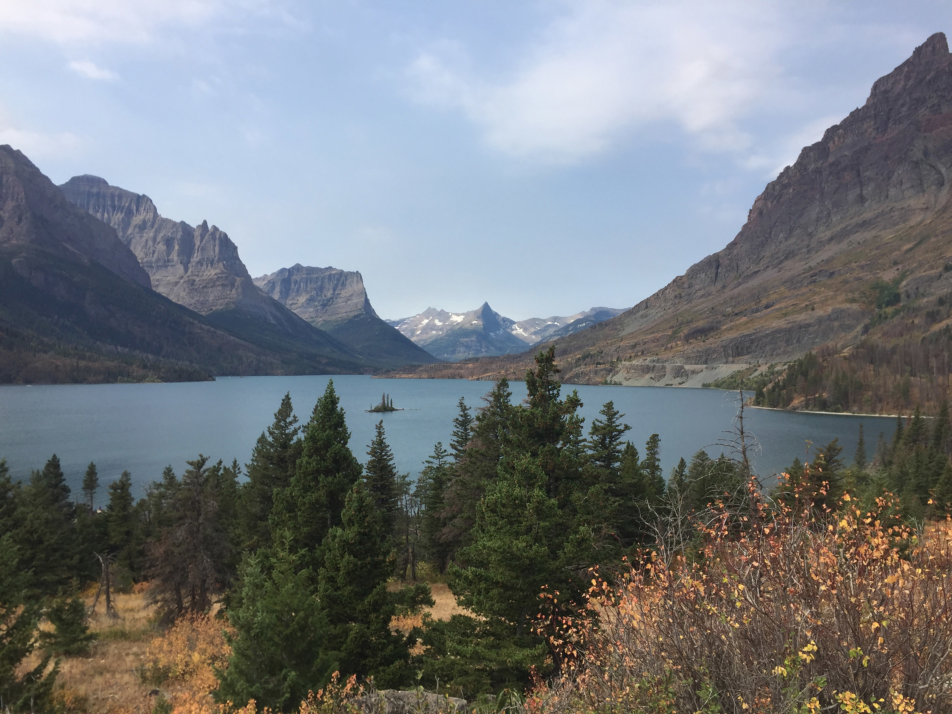 This Sept. 4, 2017 shows a view from the Going-to-the-Sun Road in Glacier National Park in Montana, with a lake ringed by mountains and tall trees.<br /> (Beth J. Harpaz / AP Photo)