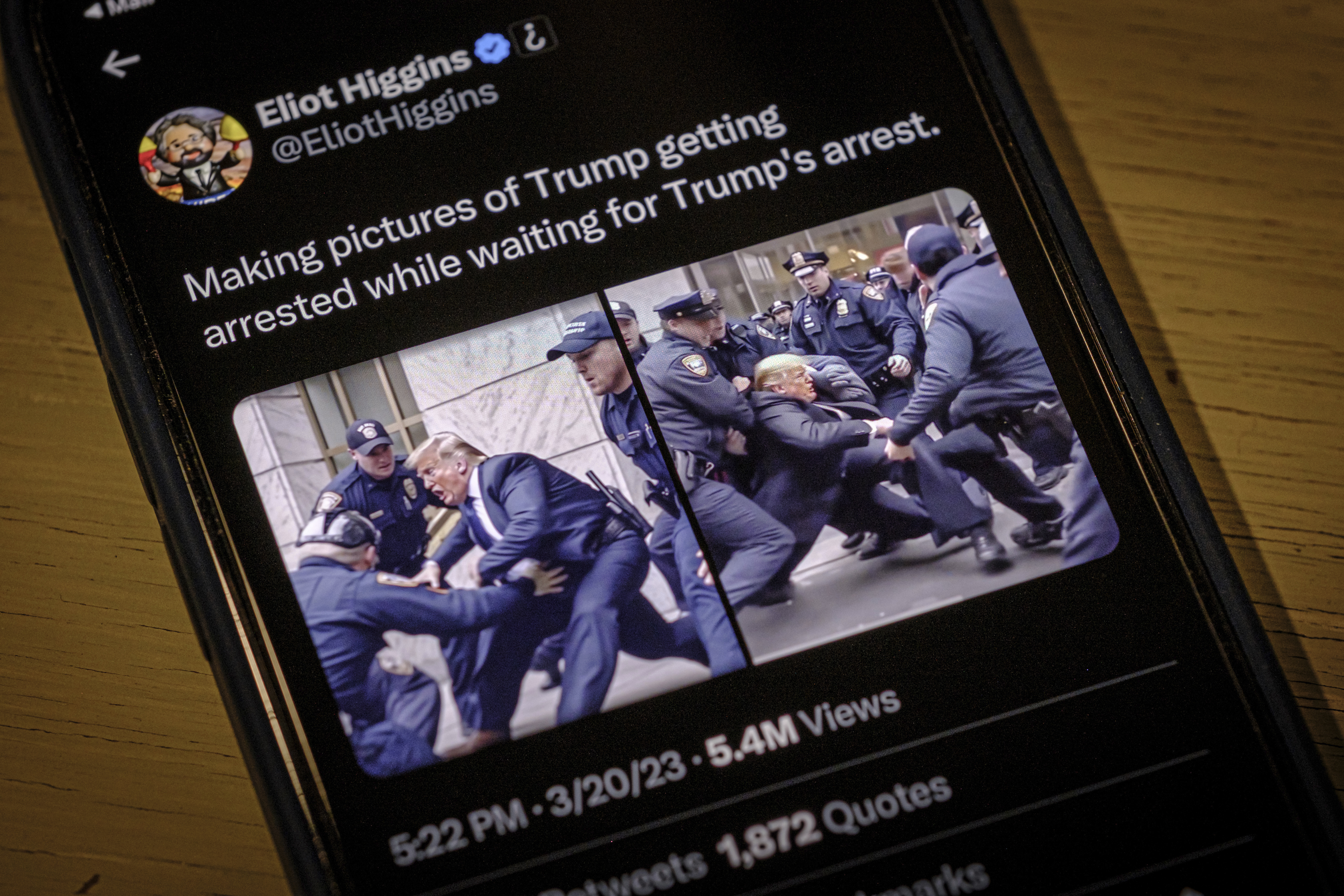 Images created by Eliot Higgins with the use of artificial intelligence show a fictitious skirmish with Donald Trump and New York City police officers posted on Higgins&#039; Twitter account, as photographed on an iPhone in Arlington, Va., Thursday, March 23, 2023. The highly detailed, sensational images, which are not real, were produced using a sophisticated and widely accessible image generator.<br />(J. David Ake / AP Photo)