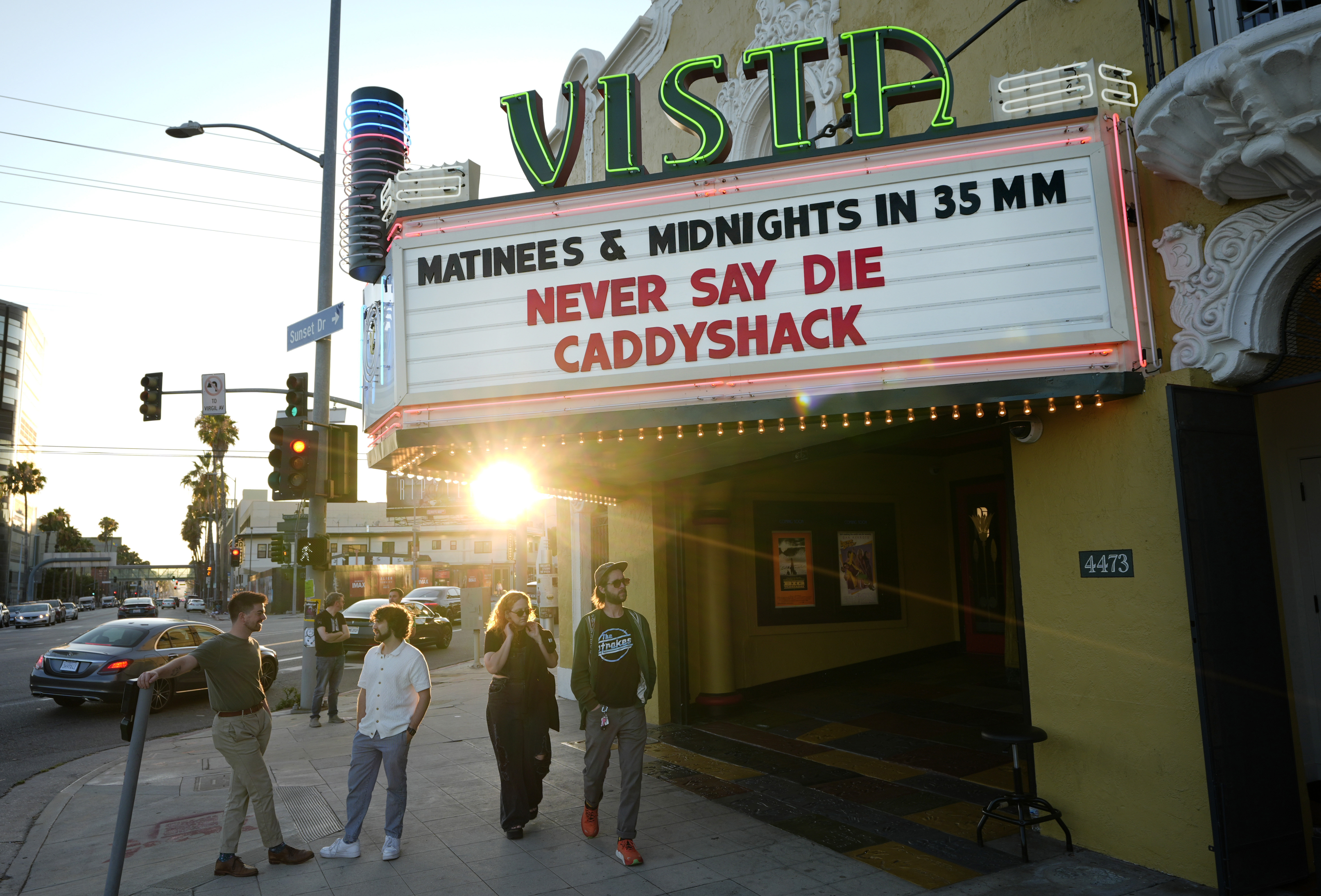 Pedestrians gather under the marquee of the Vista Theatre, Friday, Aug. 2, 2024, in Los Angeles.<br />(Chris Pizzello / AP Photo)