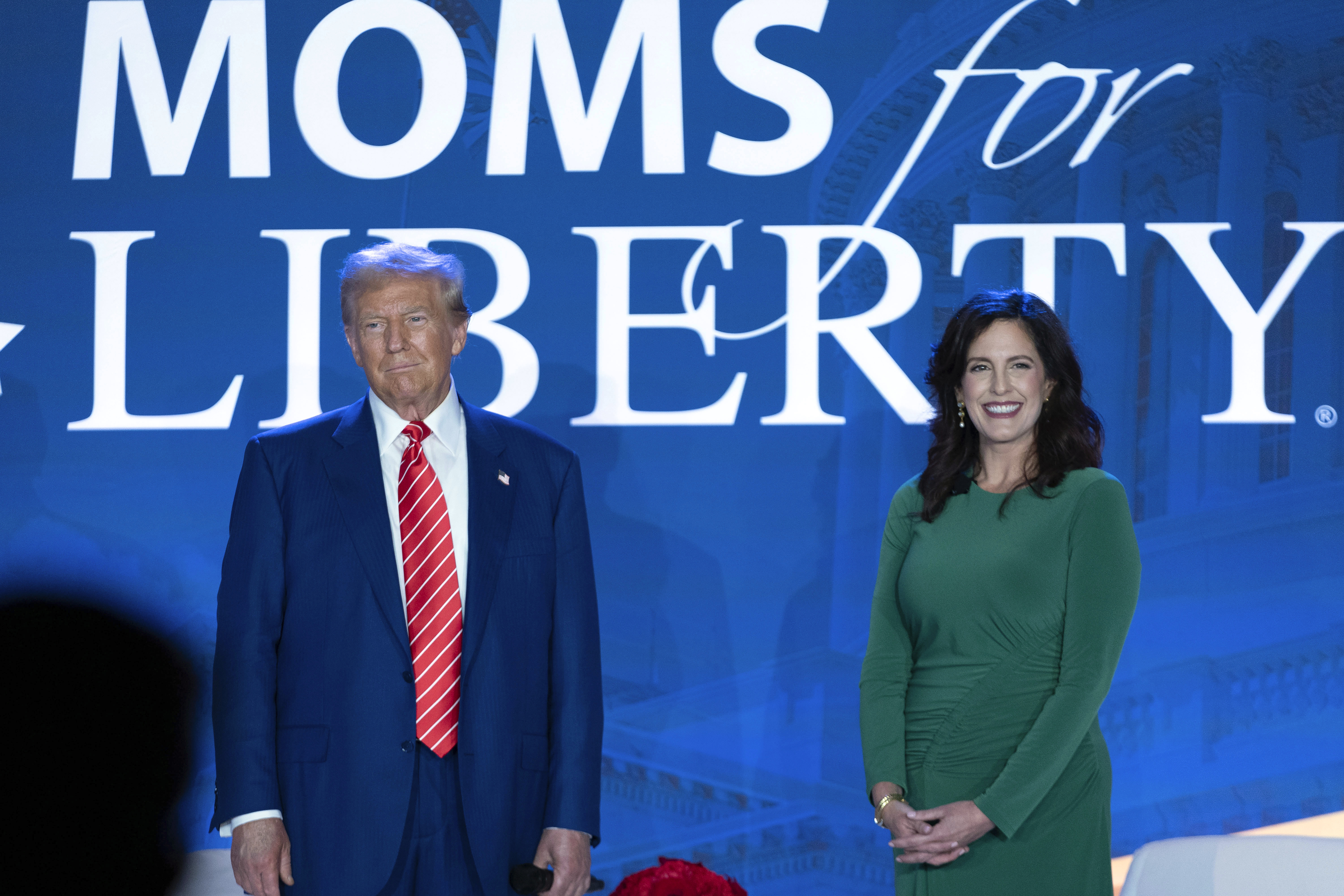 Then Republican presidential nominee Donald Trump stands with Moms for Liberty co-founder Tiffany Justice during an event at the group&#039;s annual convention in Washington, Friday, Aug. 30, 2024.<br />(Jose Luis Magana / AP Photo)