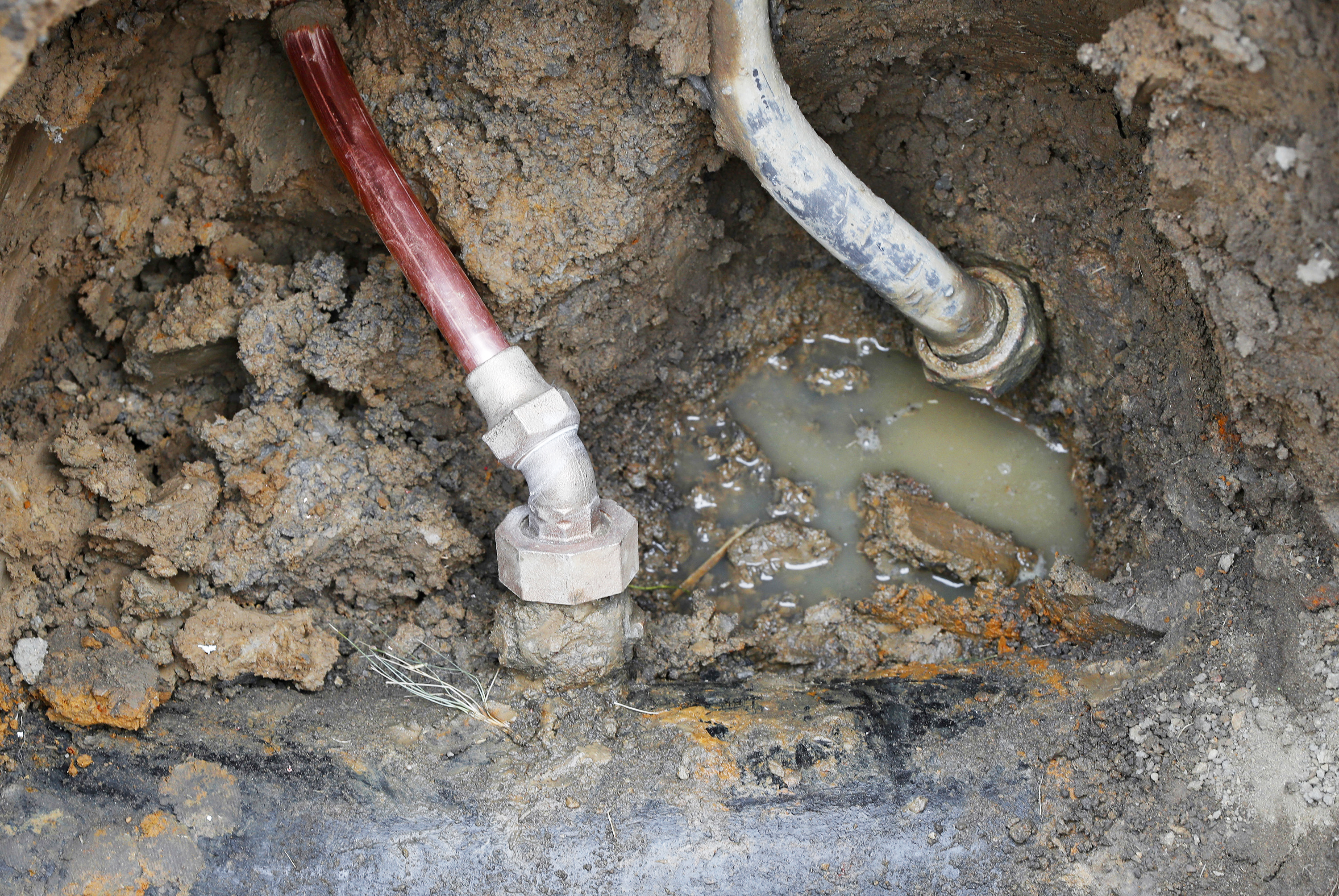 A copper water supply line (left) is shown connected to a water main after being installed for lead pipe (right) July 20, 2018, in Flint, Mich.<br />(Paul Sancya / AP Photo)