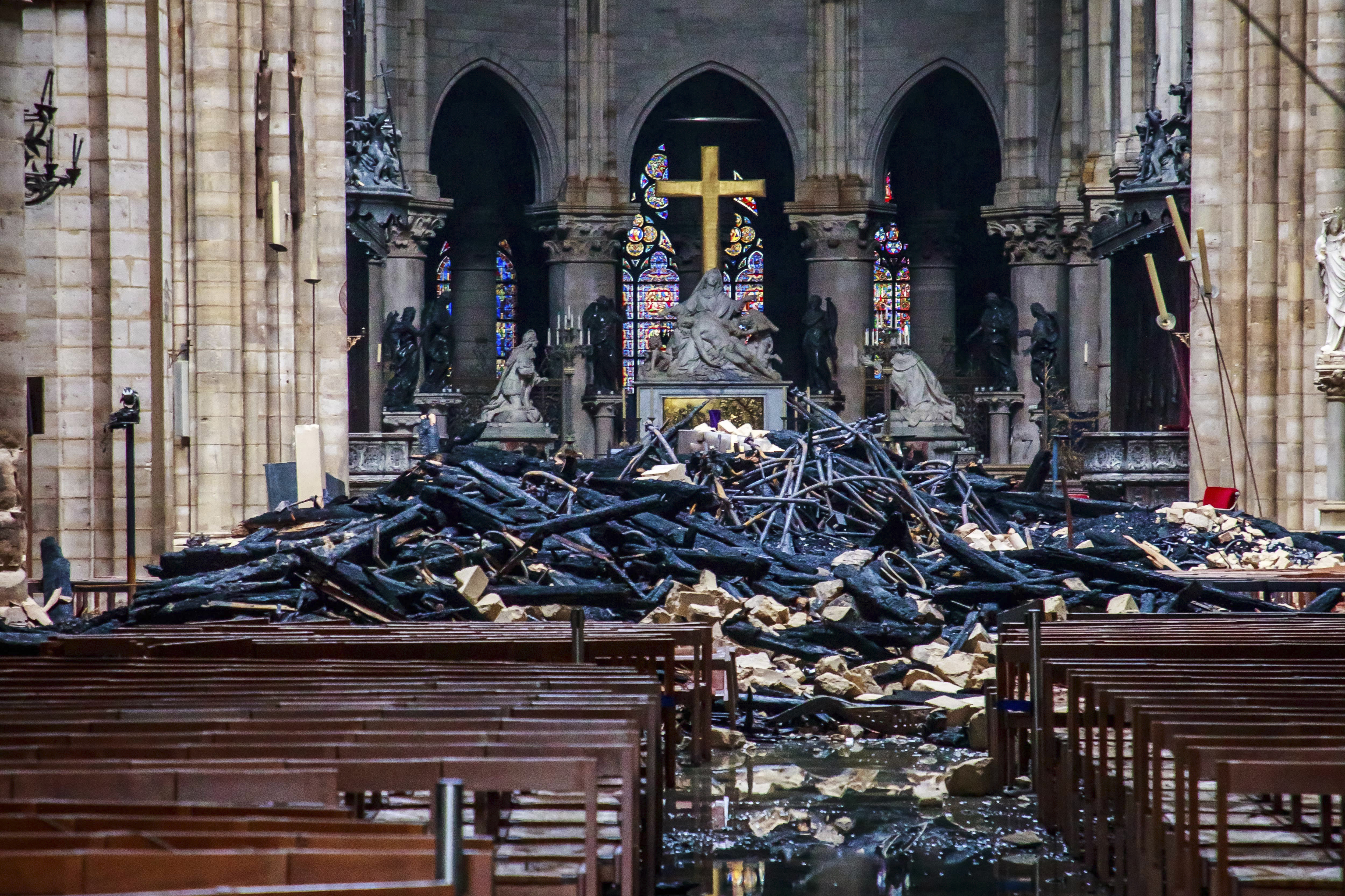 A hole is seen in the dome inside Notre Dame cathedral after the fire in Paris, Tuesday, April 16, 2019. The Cathedral is set to reopen to the public on Sunday, December 8, 2024.<br />(Christophe Petit Tesson / AP Photo)