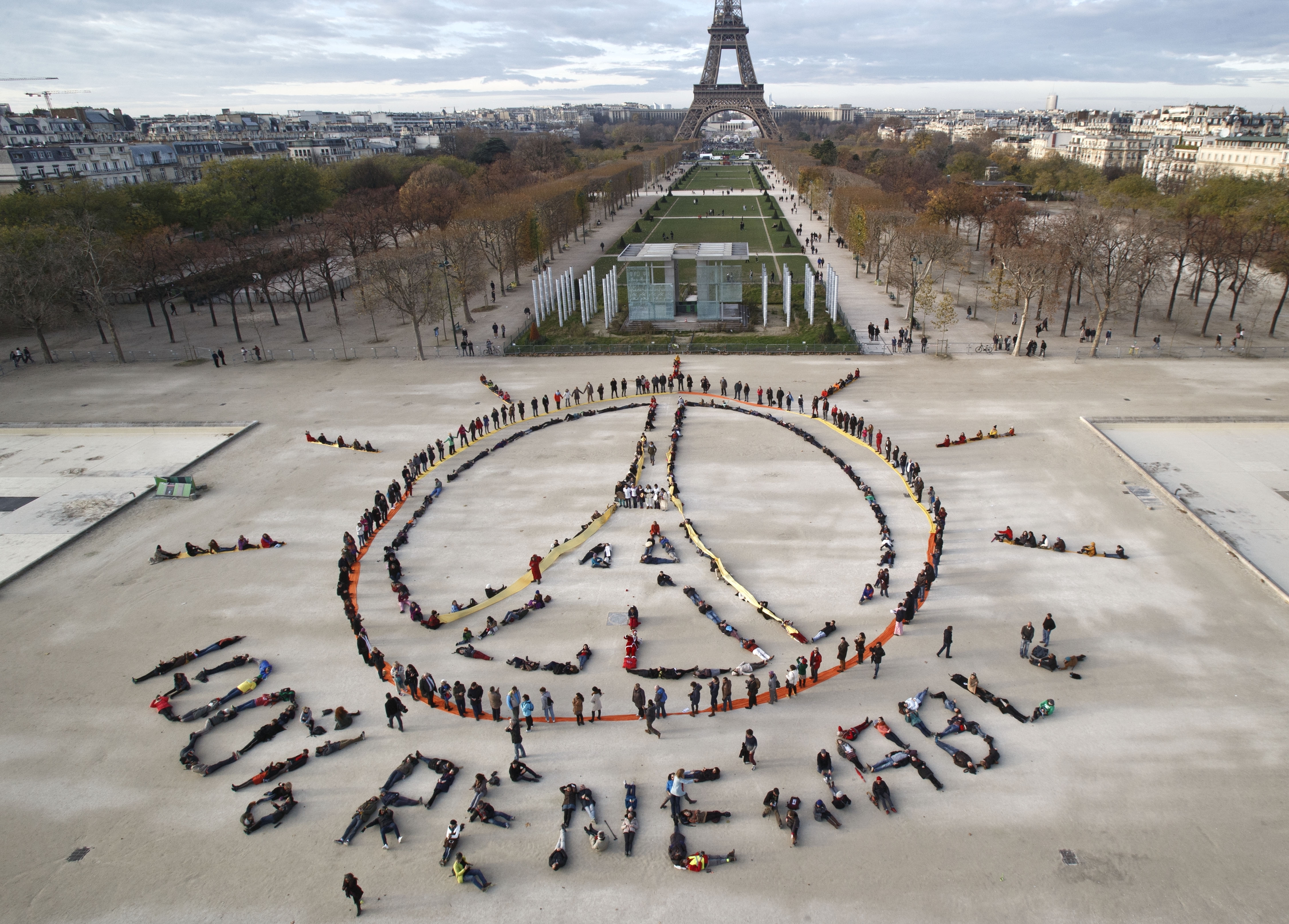 Environmentalist activists form a human chain representing the peace sign and the spelling out &quot;100% Renewable&quot;, on the side line of the COP21, United Nations Climate Change Conference near the Eiffel Tower in Paris on Dec. 6, 2015.<br />(Michel Euler / AP Photo)