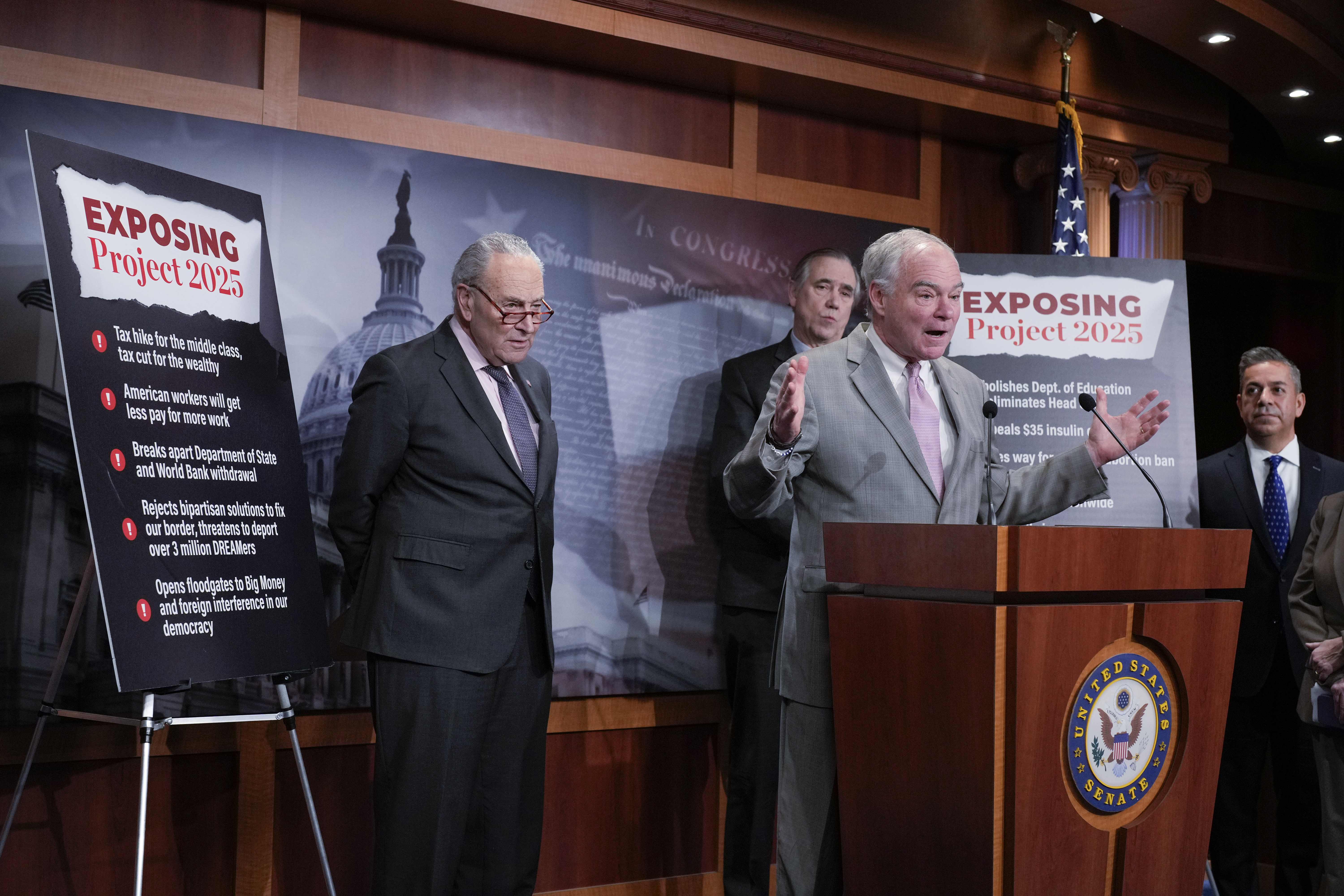 From left: Senate Minority Leader Chuck Schumer, D-N.Y., Sen. Jeff Merkley, D-Ore. (rear) Sen. Tim Kaine, D-Va., and Sen. Ben Ray Lujan, D-N.M., criticize Russ Vought, an author of the conservative handbook Project 2025 and President Donald Trump&#039;s pick to run the Office of Management and Budget, at a news conference at the Capitol in Washington, Thursday, Jan. 23, 2025.<br />(J. Scott Applewhite / AP Photo)