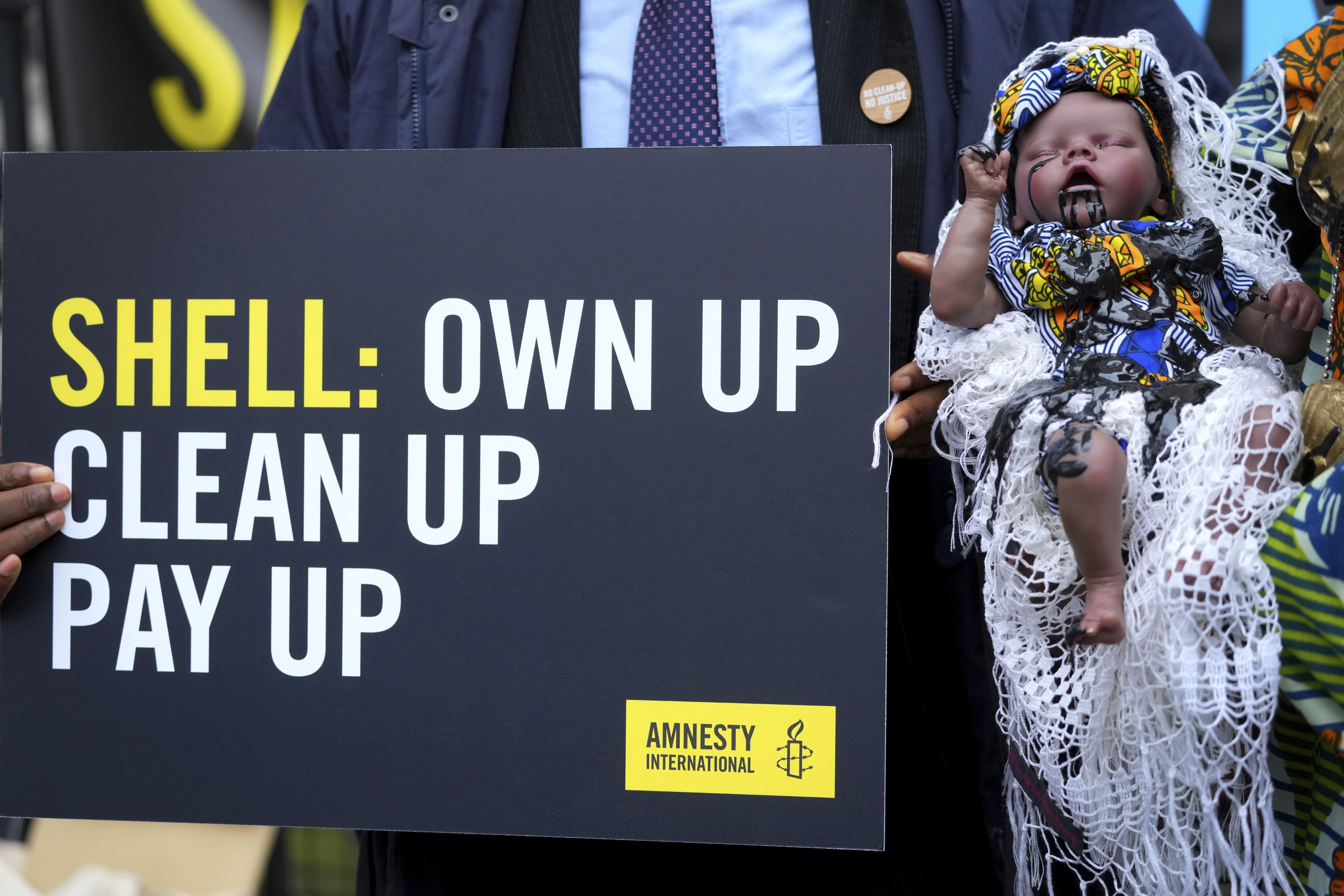 Activists hold &#039;Ecocide Babe&#039; that has simulated crude oil congealed around its mouth highlighting the public health impact of environmental devastation caused by Shell in Nigeria, outside The Royal Courts of Justice, ahead of the Ogale and Bille communities versus Shell court case in London, Thursday, Feb. 13, 2025.<br />(Kirsty Wigglesworth / AP Photo)