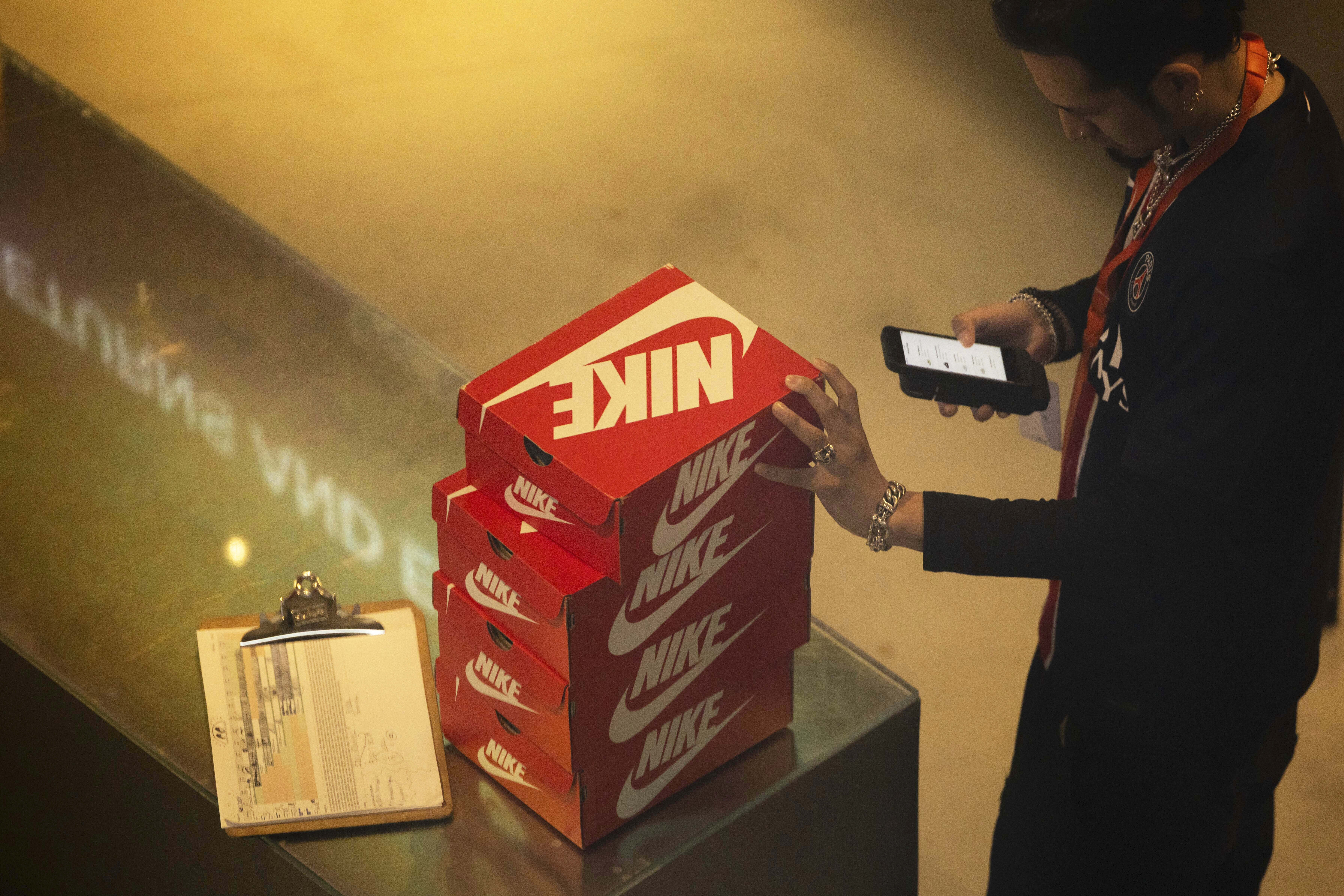 An employee holds Nike shoe boxes at the Nike store on the 5th Avenue, Monday, April 7, 2025, in New York.<br />(Yuki Iwamura / AP Photo)