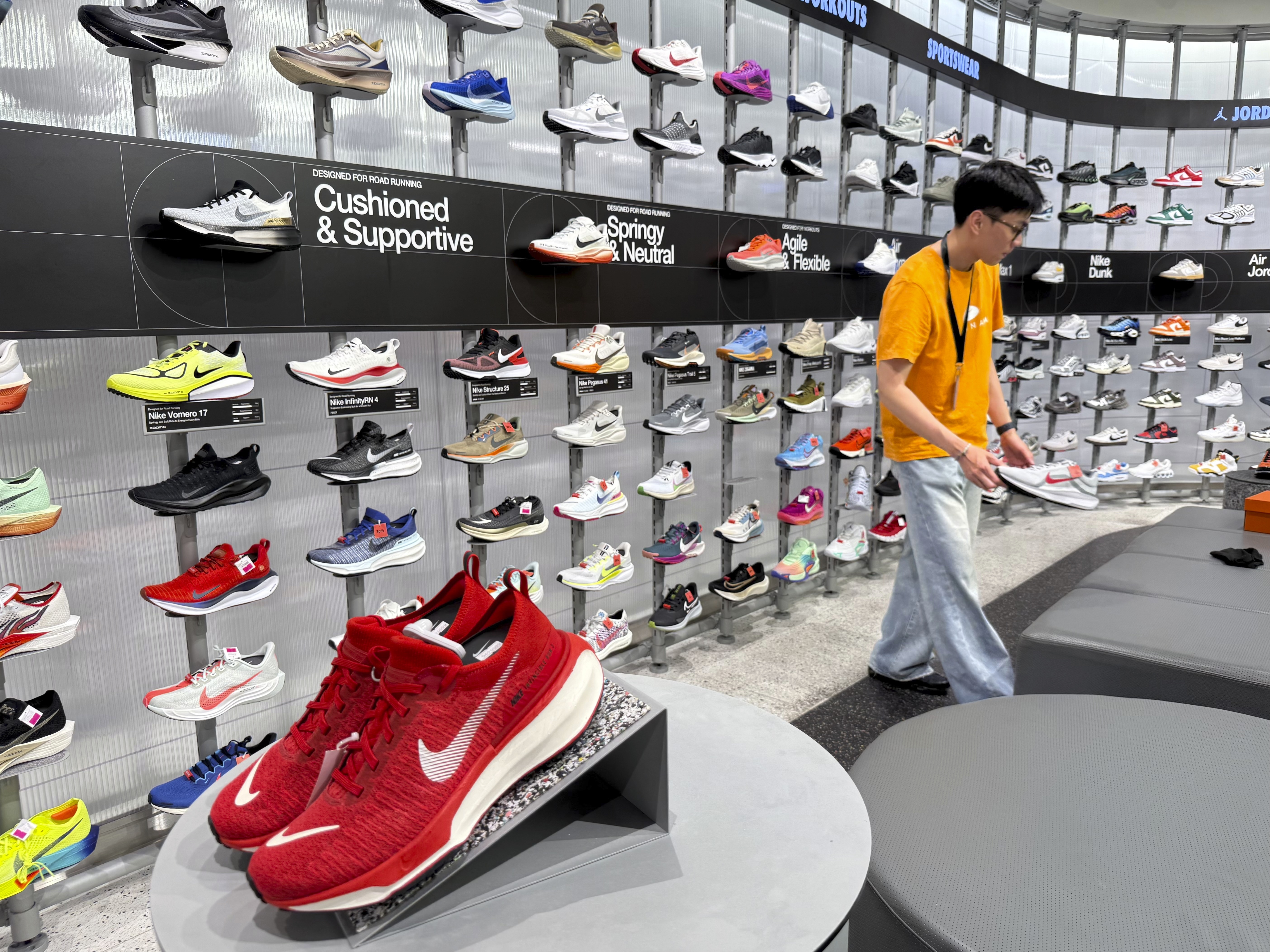 A sales staff arranges shoes at a Nike shop in Hanoi, Vietnam on Thursday, April 10, 2025.<br />(Hau Dinh / AP Photo)