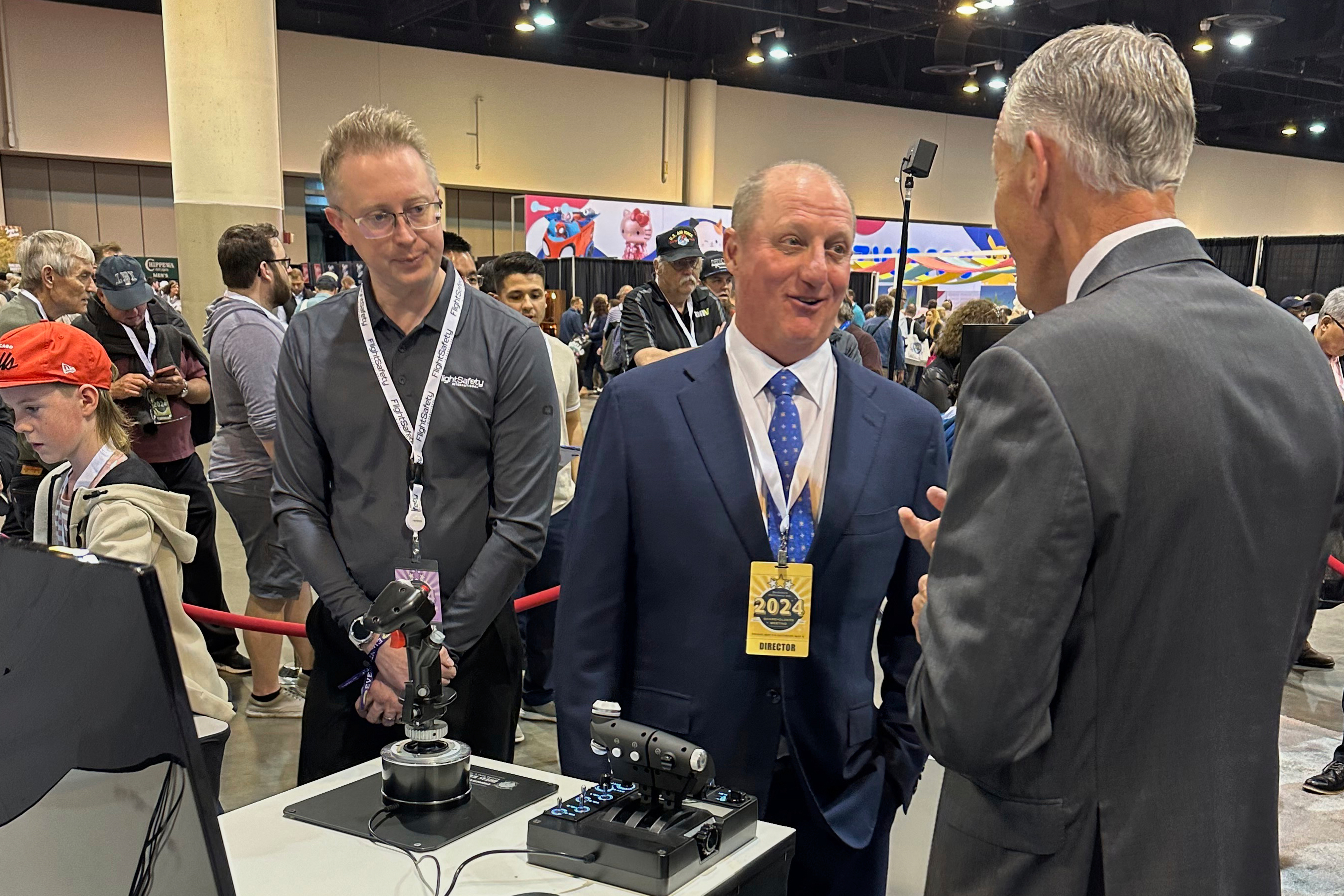 Berkshire Hathaway Vice Chairman Greg Abel (center) checks out the flight simulators offered by one of Berkshires companies, Flight Safety as he toured the exhibit hall Friday, May 3, 2024, in Omaha, Neb. ahead of Saturday&#039;s meeting.<br />(Josh Funk / AP Photo)