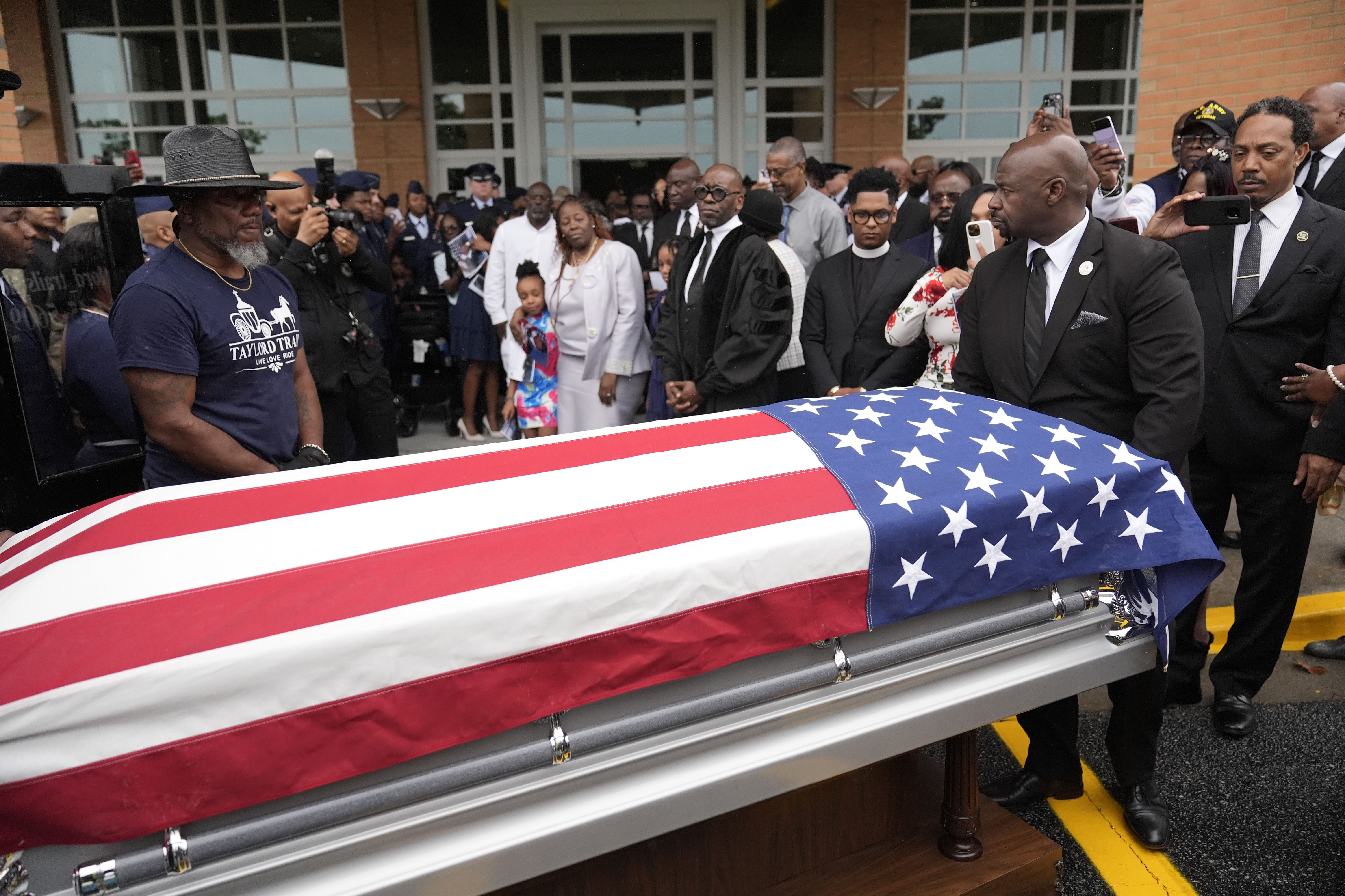 Friends and family of Roger Fortson watch as his casket leaves for the cemetery at New Birth Missionary Baptist Church on May 17, 2024, in Stonecrest, Ga.<br />(Brynn Anderson / AP Photo)