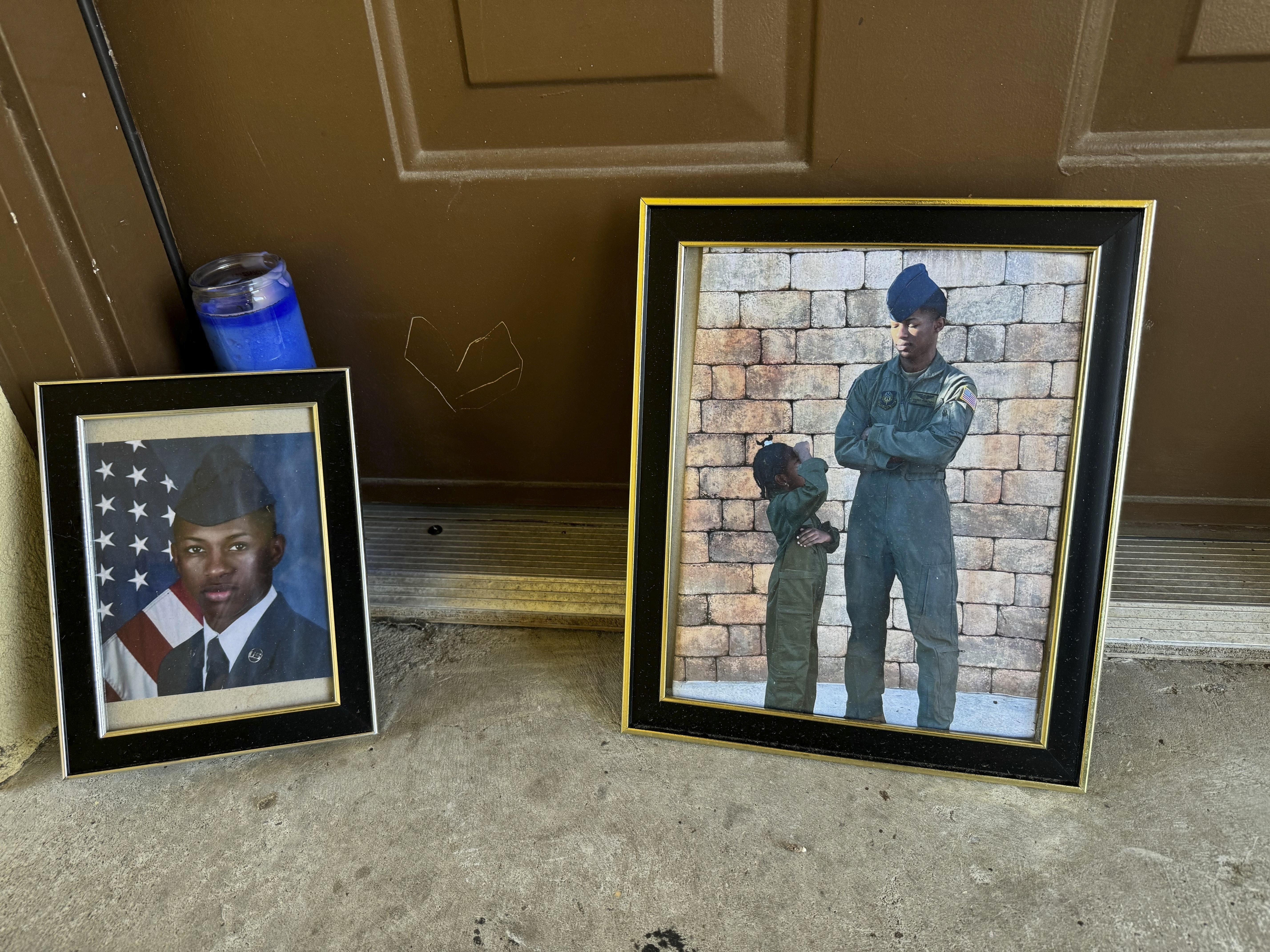 Candles and framed photos of Roger Fortson, a U.S. Air Force senior airman who was fatally shot by a Fla. sheriff&#039;s deputy on May 3, 2024, sit in the doorway of the apartment where he was killed in Fort Walton Beach, Fla., on Aug. 23.<br />(Kate Payne / AP Photo)