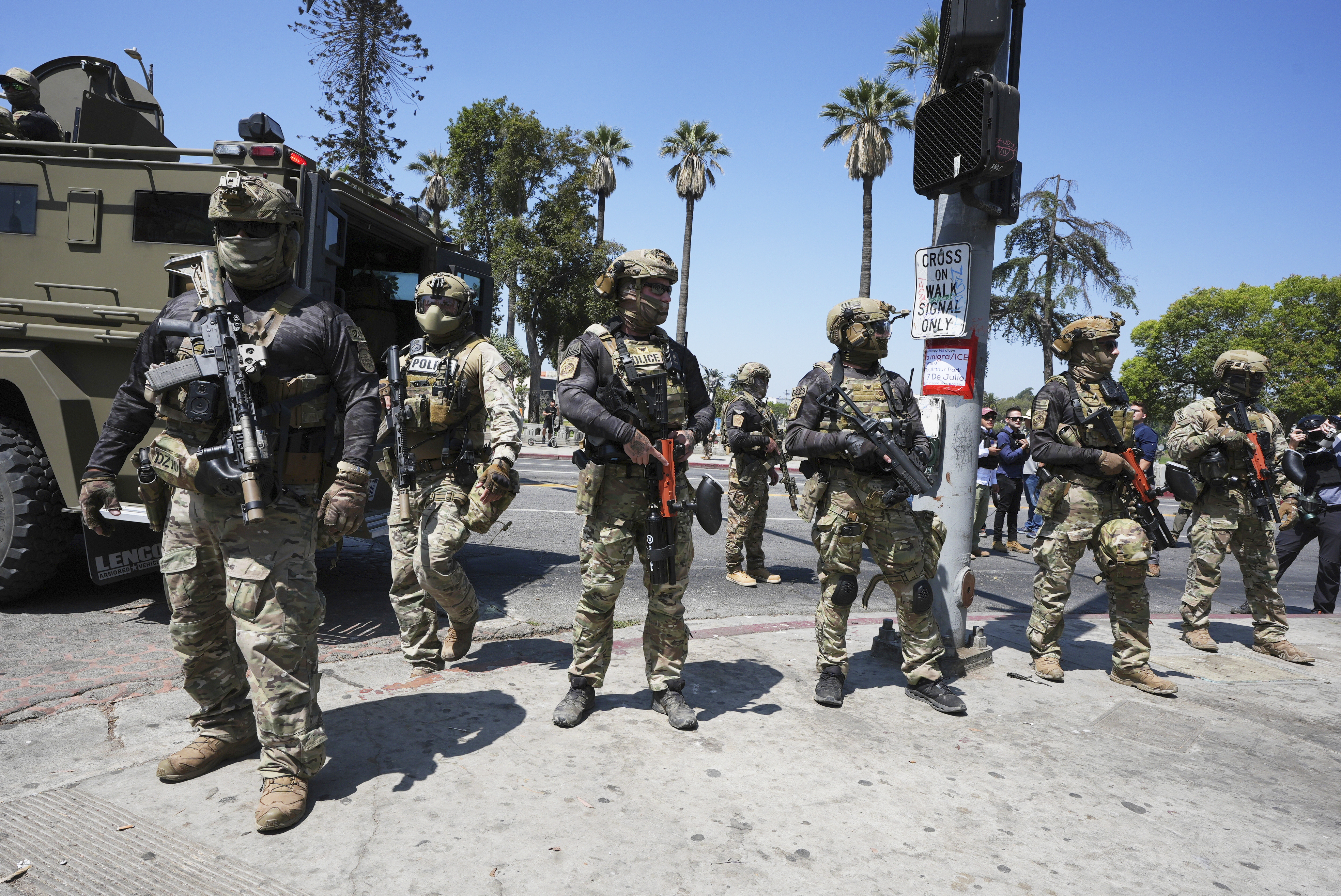 Federal agents stage at MacArthur Park Monday, July 7, 2025, in Los Angeles.<br /> (Damian Dovarganes / AP Photo)