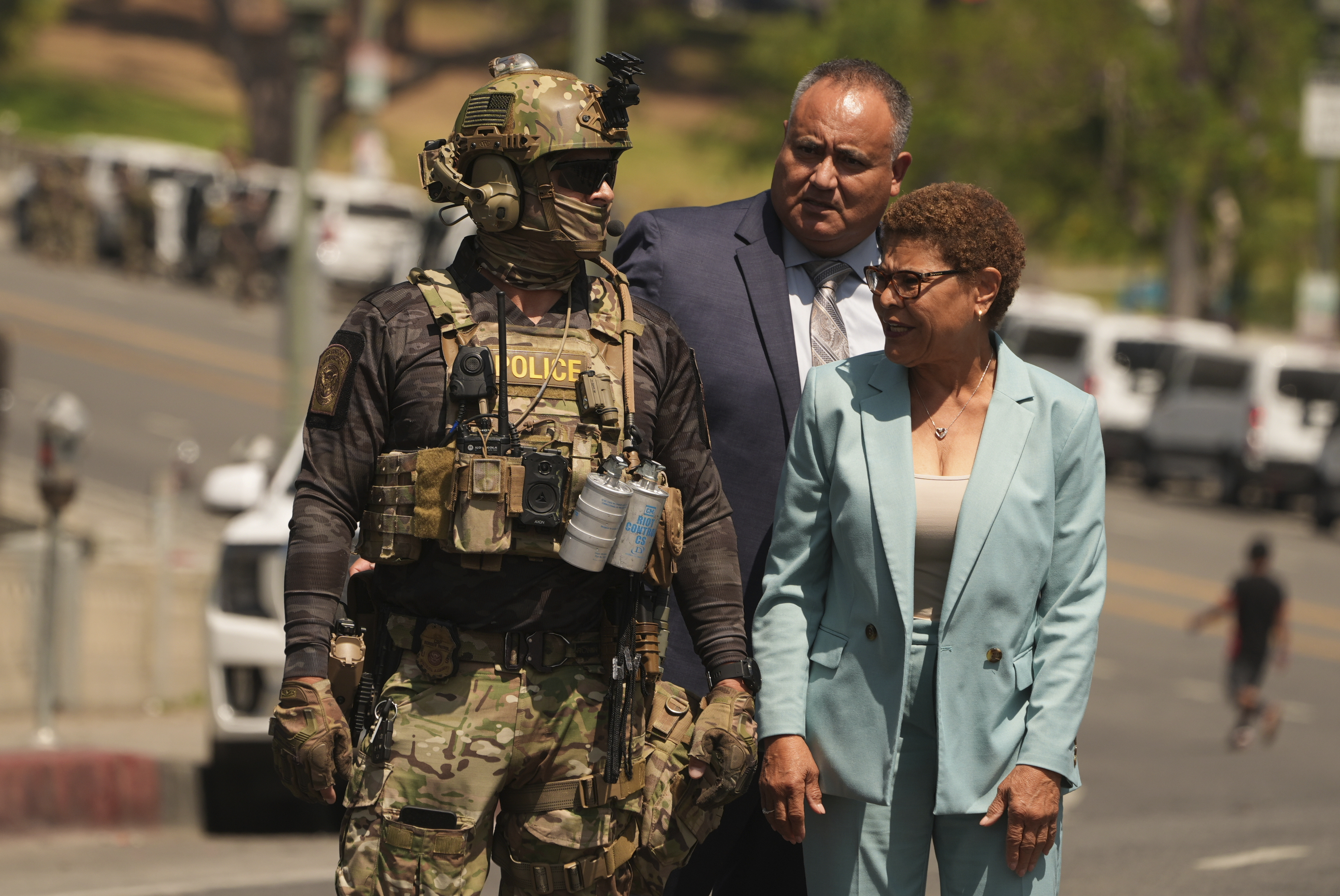 Los Angeles Mayor Karen Bass walks with a federal agent at MacArthur Park Monday, July 7, 2025, in Los Angeles.<br />(Damian Dovarganes / AP Photo)