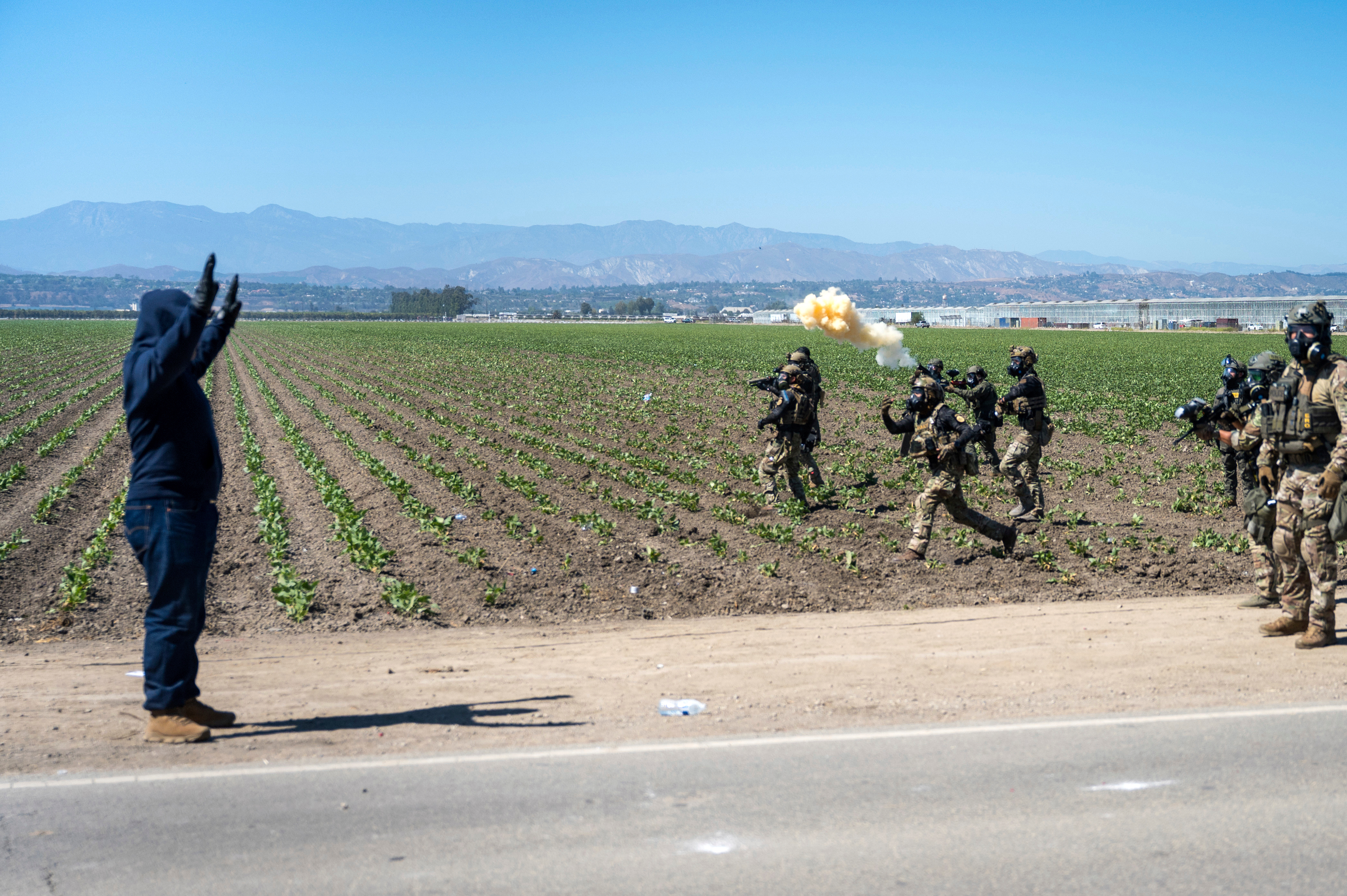 Federal immigration agents toss tear gas at protesters during a raid in the agriculture area of Camarillo, Calif., Thursday, July 10, 2025.<br />(Michael Owen Baker / AP Photo)
