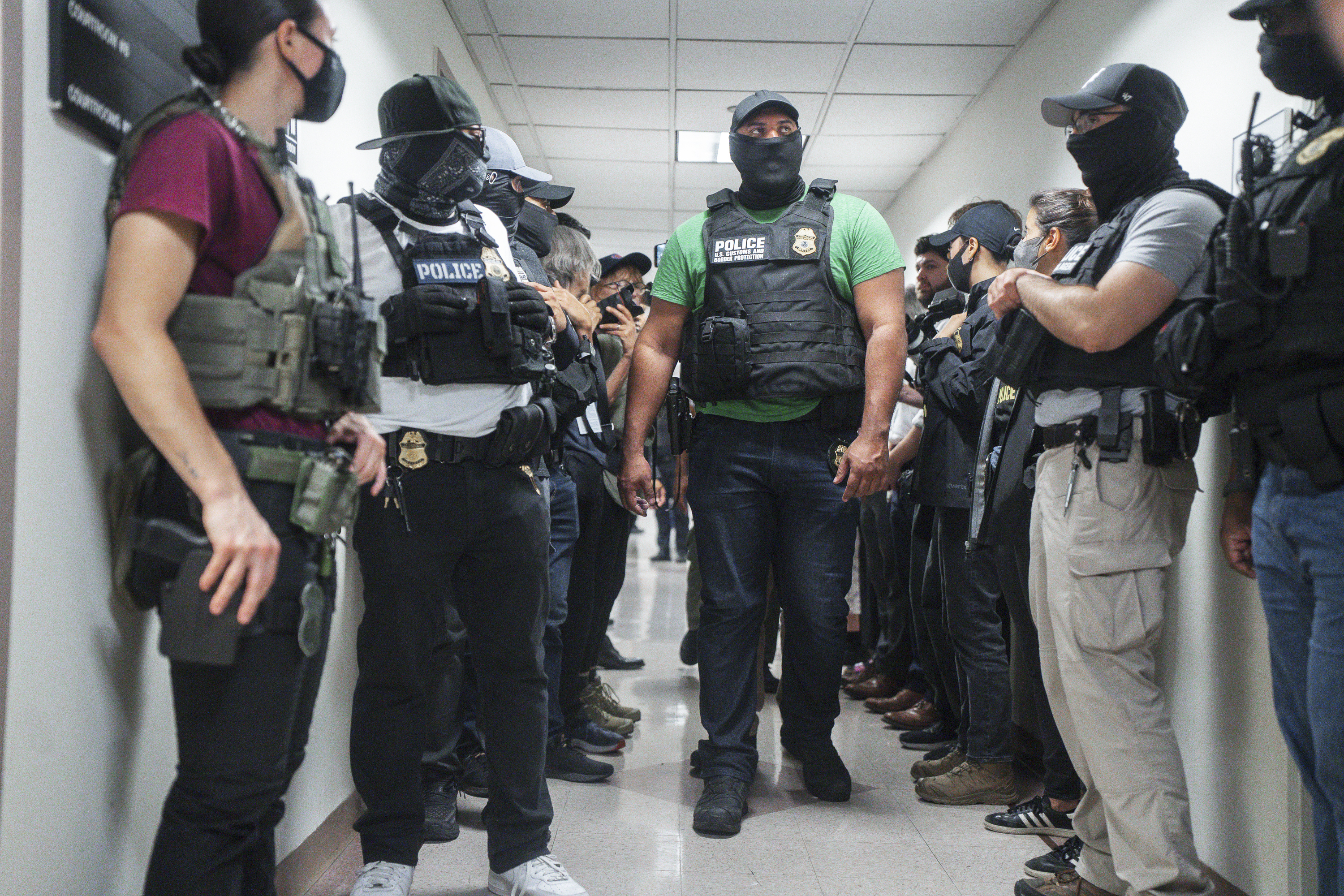 Masked federal agents wait outside an immigration courtroom, July 8, 2025, in New York.<br />(Olga Fedorova / AP Photo)