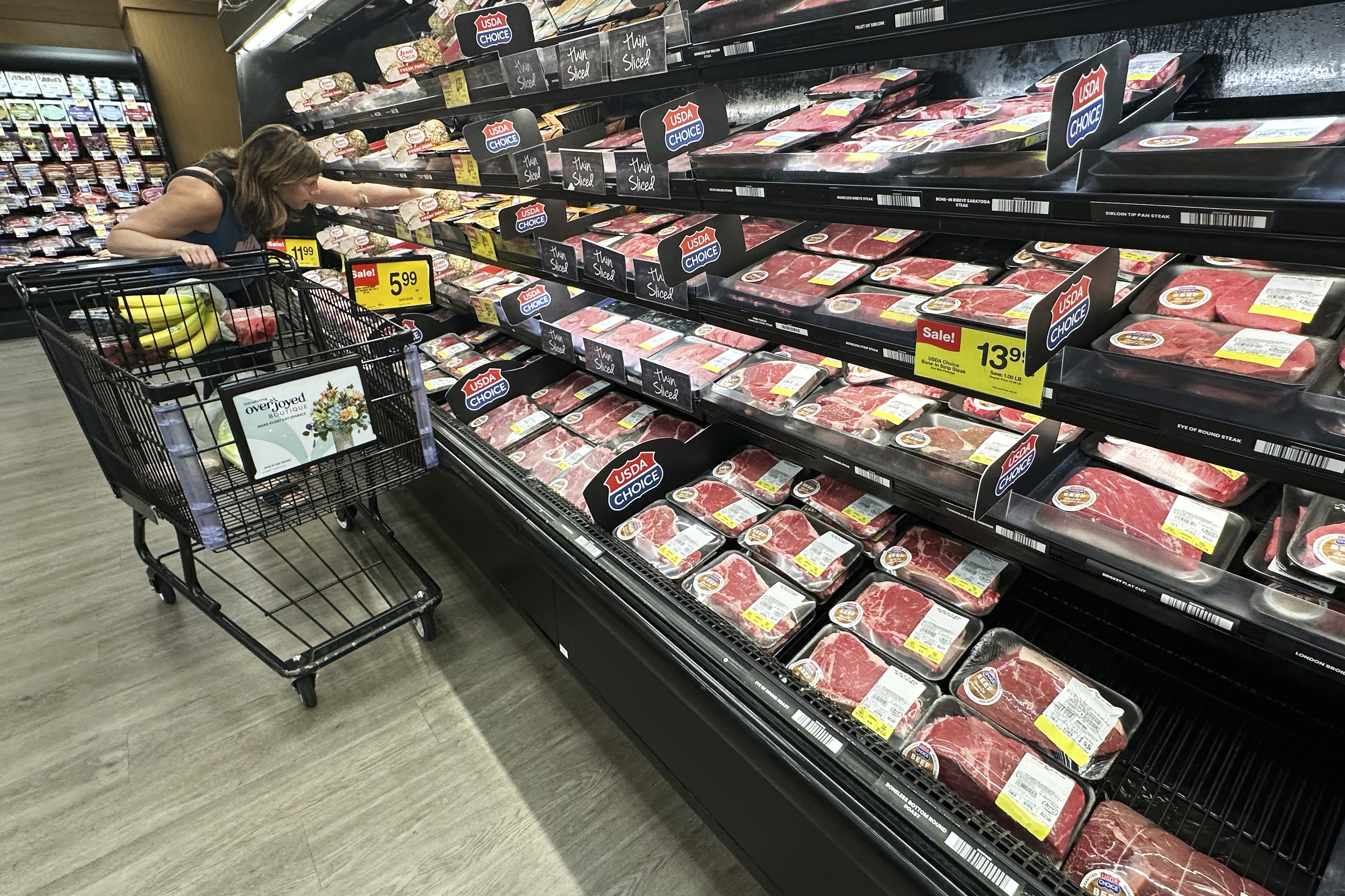 A shopper compares beef prices at a grocery store in Mount Prospect, Ill., Thursday, July 17, 2025.<br />(Nam Y. Huh / AP Photo)