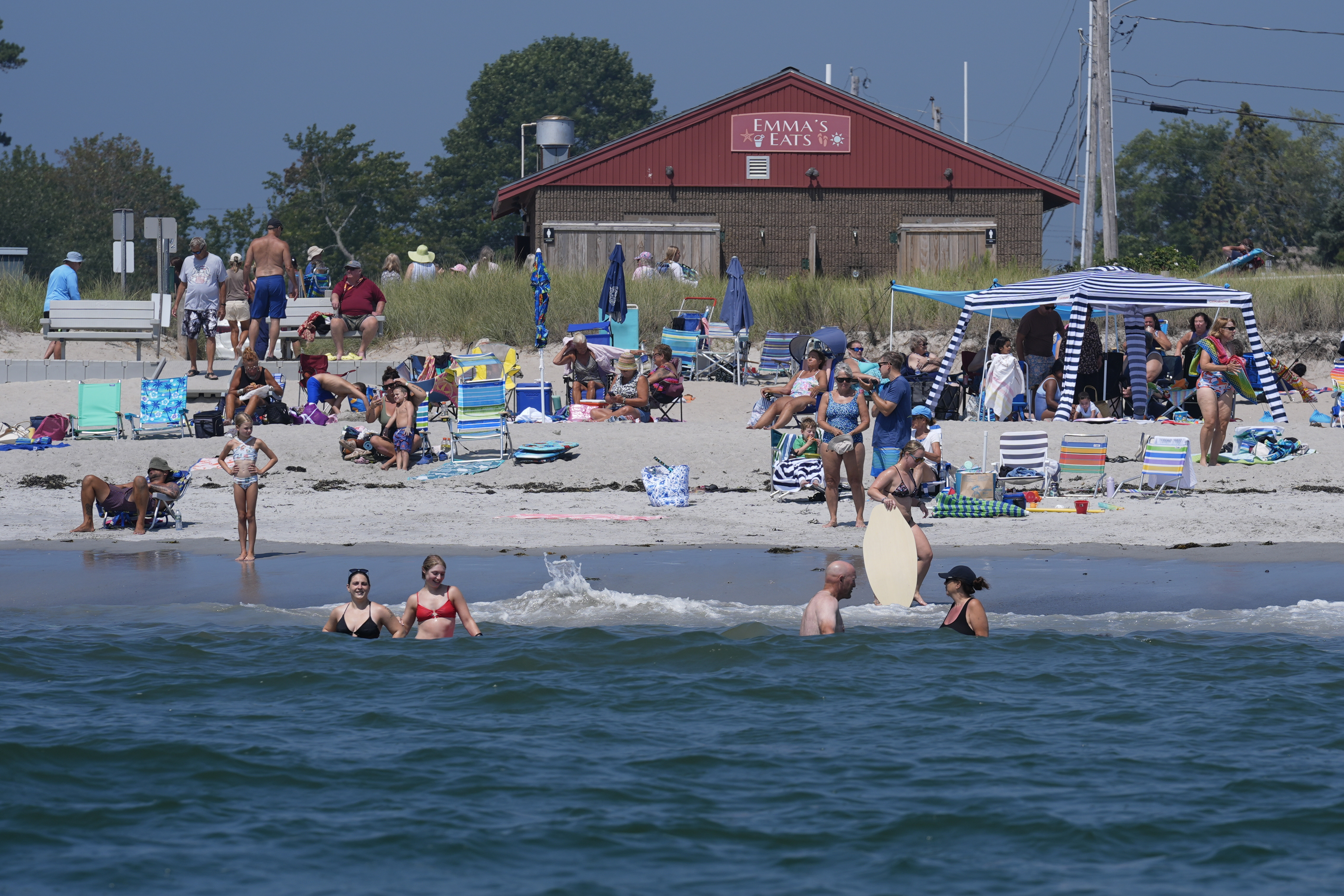 Visitors enjoy the summer weather not far from recent sightings of white sharks, Wednesday, Aug. 13, 2025, in Scarborough, Maine.<br />(Robert F. Bukaty / AP Photo)