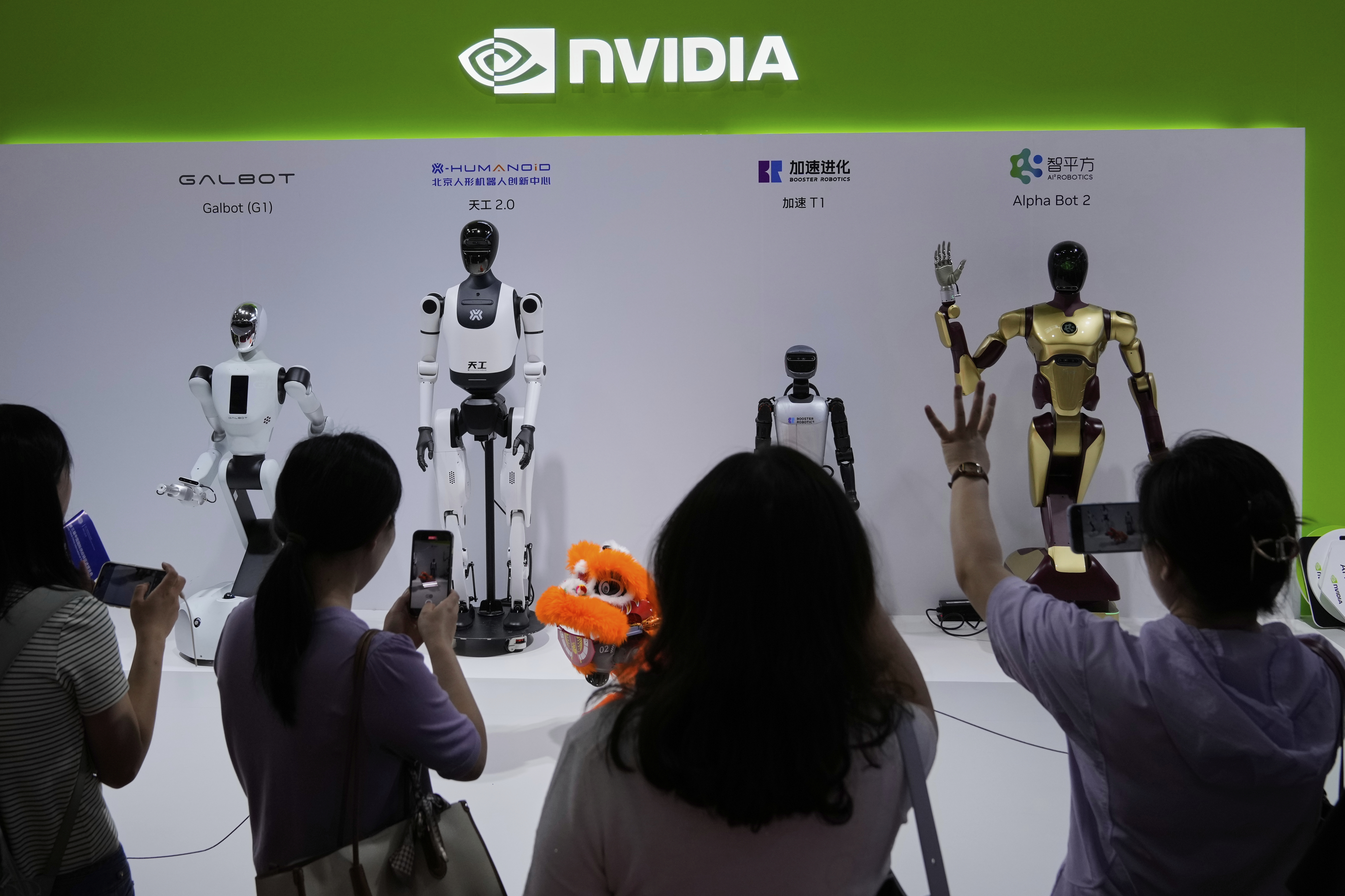 Visitors give commands to a robot at Nvidia&#039;s booth during the 3rd China International Supply Chain Expo at the China International Exhibition Center, in Beijing, July 18, 2025.<br />(Mahesh Kumar A. / AP Photo)