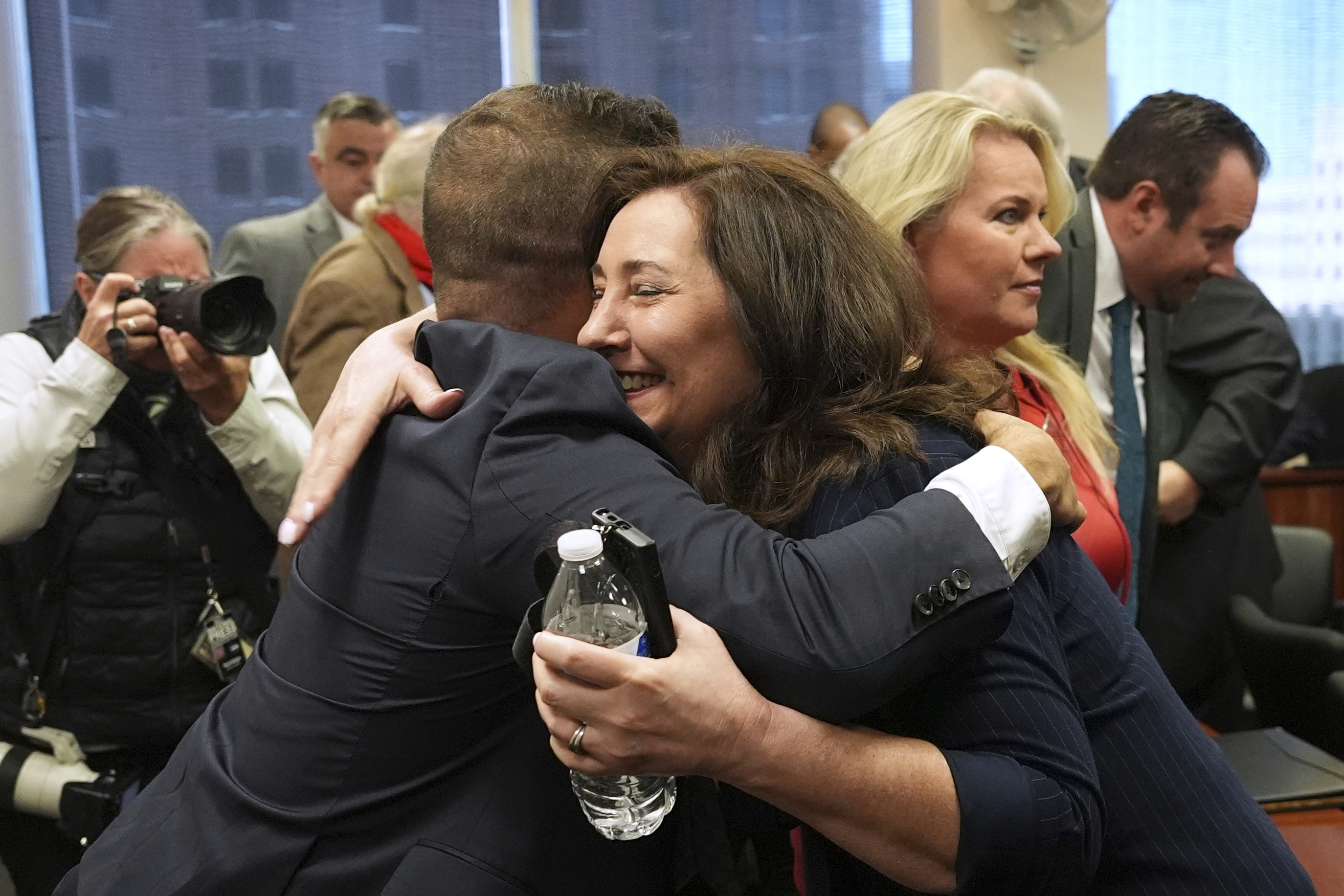 Amy Facchinello hugs an attorney after a Michigan judge dismissed the criminal cases against 15 people accused of acting falsely as electors for President Donald Trump in the 2020 election Tuesday, Sept. 9, 2025 in Lansing, Mich.<br />(Paul Sancya / AP Photo)