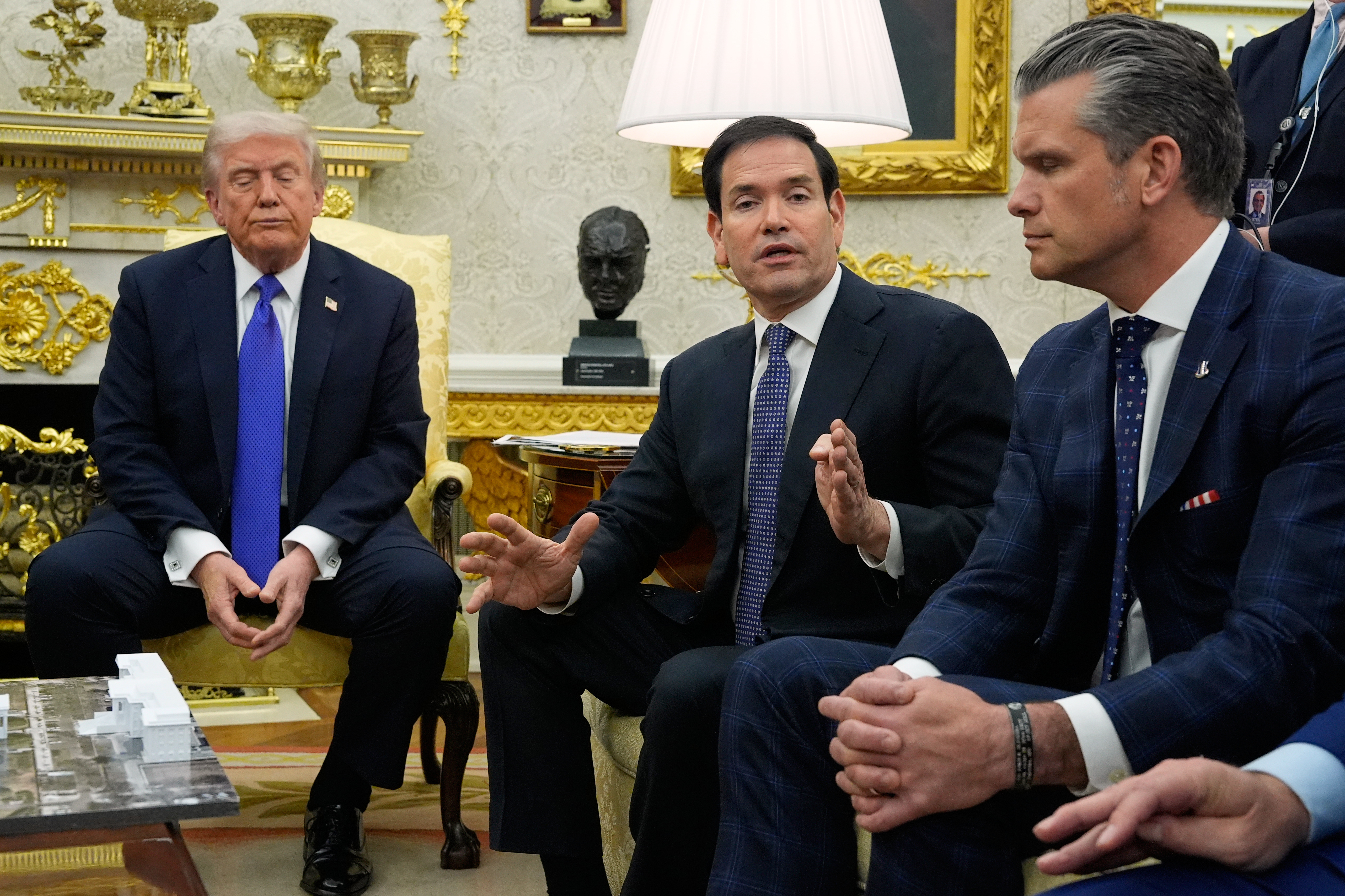 President Donald Trump and Defense Secretary Pete Hegseth listen as Secretary of State Marco Rubio speaks during a meeting with NATO Secretary General Mark Rutte in the Oval Office of the White House, Wednesday, Oct. 22, 2025, in Washington.<br />(Alex Brandon / AP Photo)