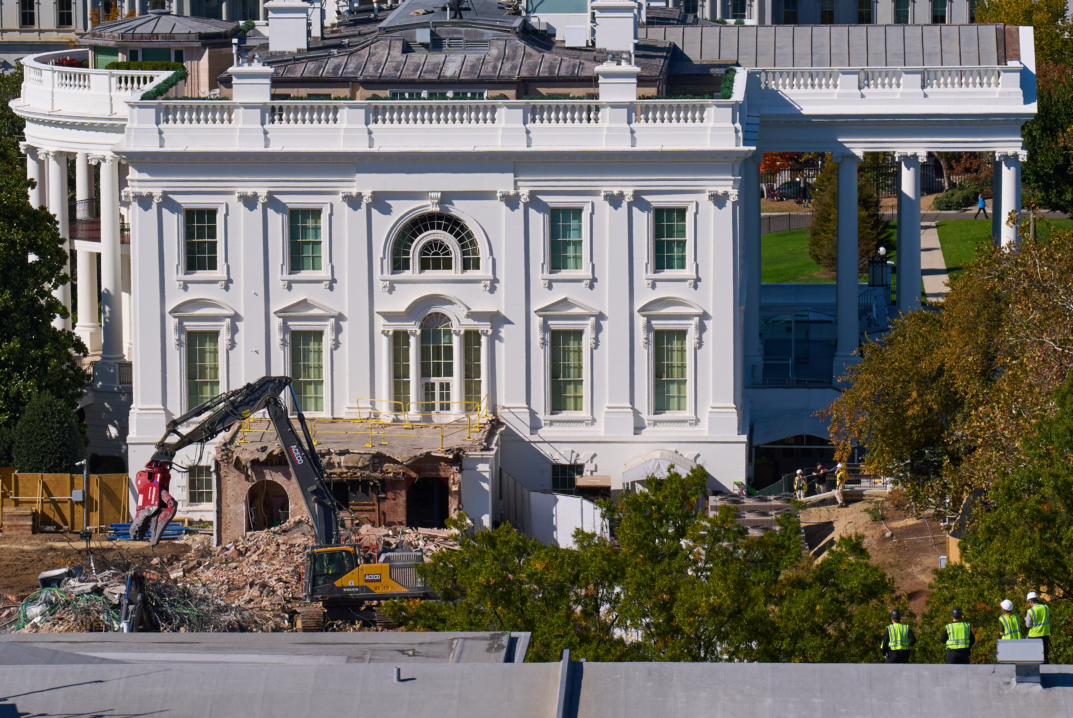 Construction workers (bottom right) atop the U.S. Treasury, watch as work continues on a largely demolished part of the East Wing of the White House, Thursday, Oct. 23, 2025, in Washington, before construction of a new ballroom.<br />(Jacquelyn Martin / AP Photo)