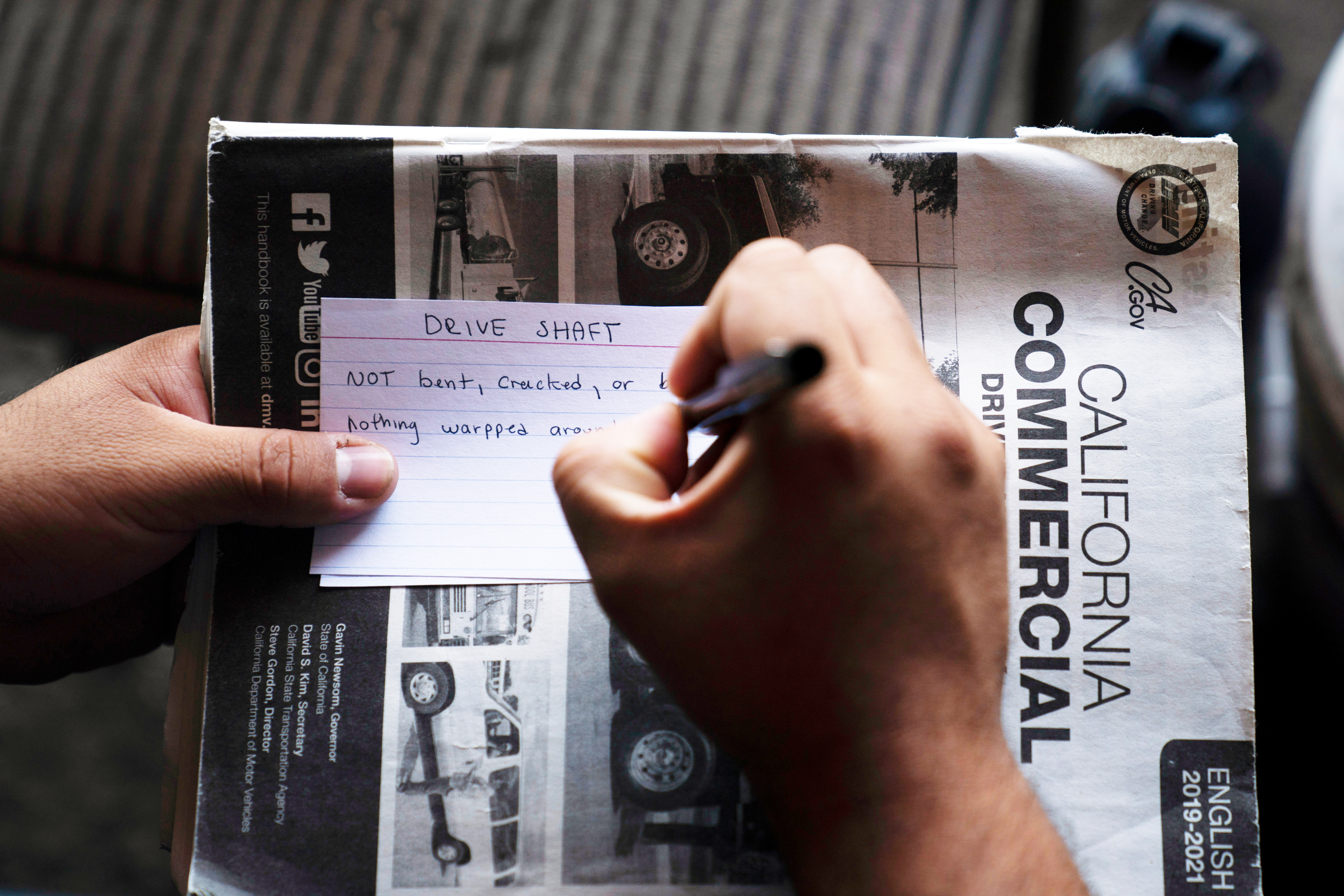 A student truck driver makes flash cards for his commercial driver&#039;s license exam while taking a class in Calif., Nov. 15, 2021.<br />(Jae C. Hong / AP Photo)
