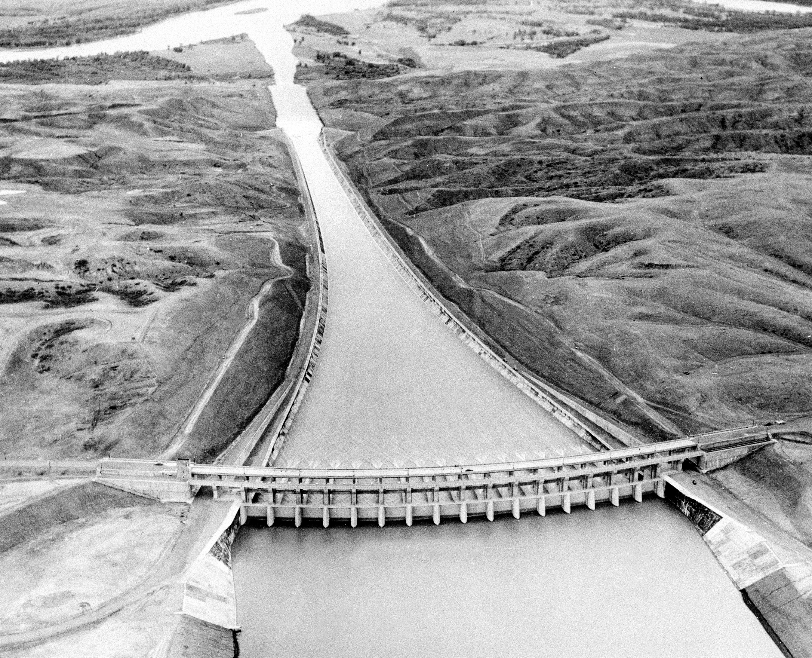 This Sept. 18, 1946 aerial view taken from a U.S. Army airplane flying over Fort Peck Lake, near Glasgow, Mont. shows operational tests of the mile-long concrete lined spillway of the Fort Peck Dam, the first of the U.S. Army Corps of Engineers&#039; dams to be completed in the Missouri River basin.<br />(AP Photo)