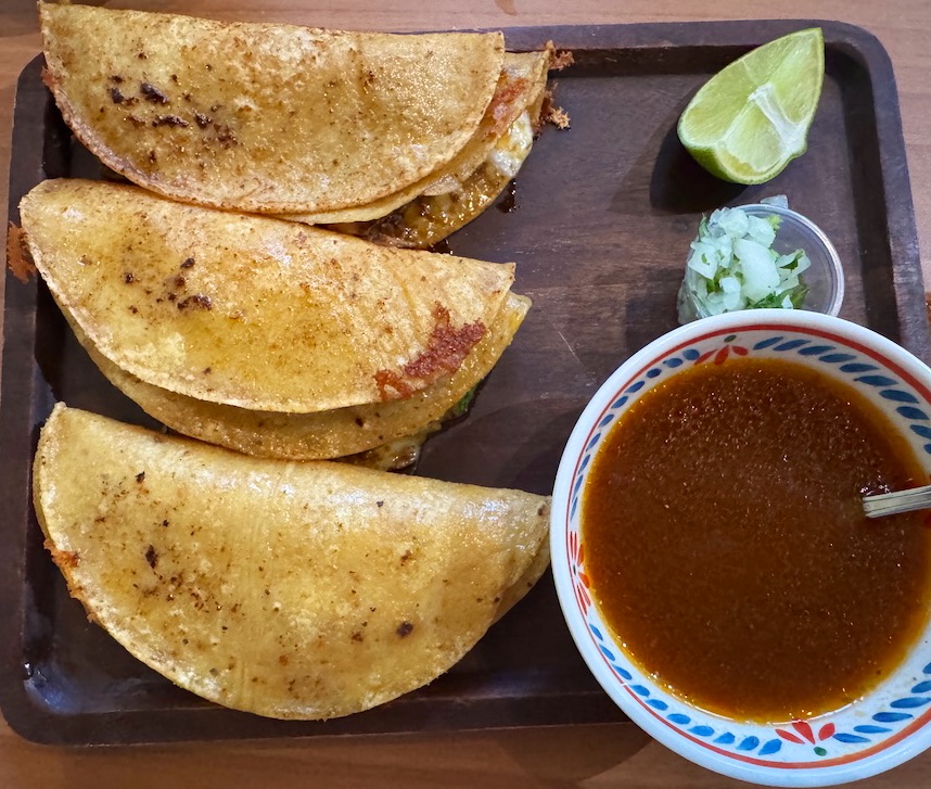 Made with a family recipe, the three birria tacos come stuffed with meat, melted cheese, onion and cilantro, with a cup of savory consommé for dipping.<br />(Sarah Baker Hansen / Flatwater Free Press)