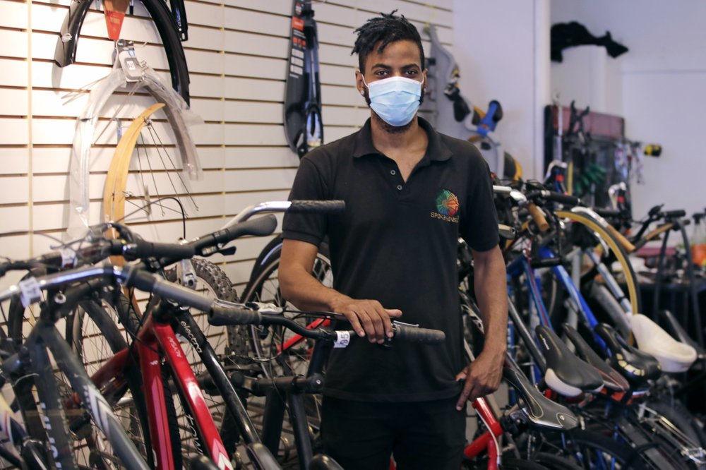 Noah Hicks, owner of Spokehouse Bikes in the Upham’s Corner neighborhood of Boston, poses at his shop on June 24, 2020. Many from outside Boston have donated to and shopped at the store which was robbed and vandalized earlier in the month. (AP)