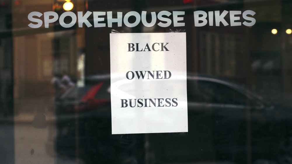 A sign in the window informs passersby that Spokehouse Bikes in the Upham’s Corner neighborhood of Boston is a Black-owned business. (AP)