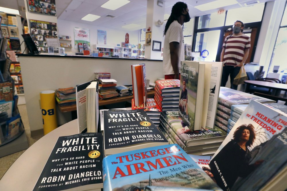 Books are displayed, including “The Tuskegee Airmen” and “White Fragility,” at the Black-owned Frugal Bookstore in the Roxbury neighborhood of Boston on June 24, 2020. (AP)