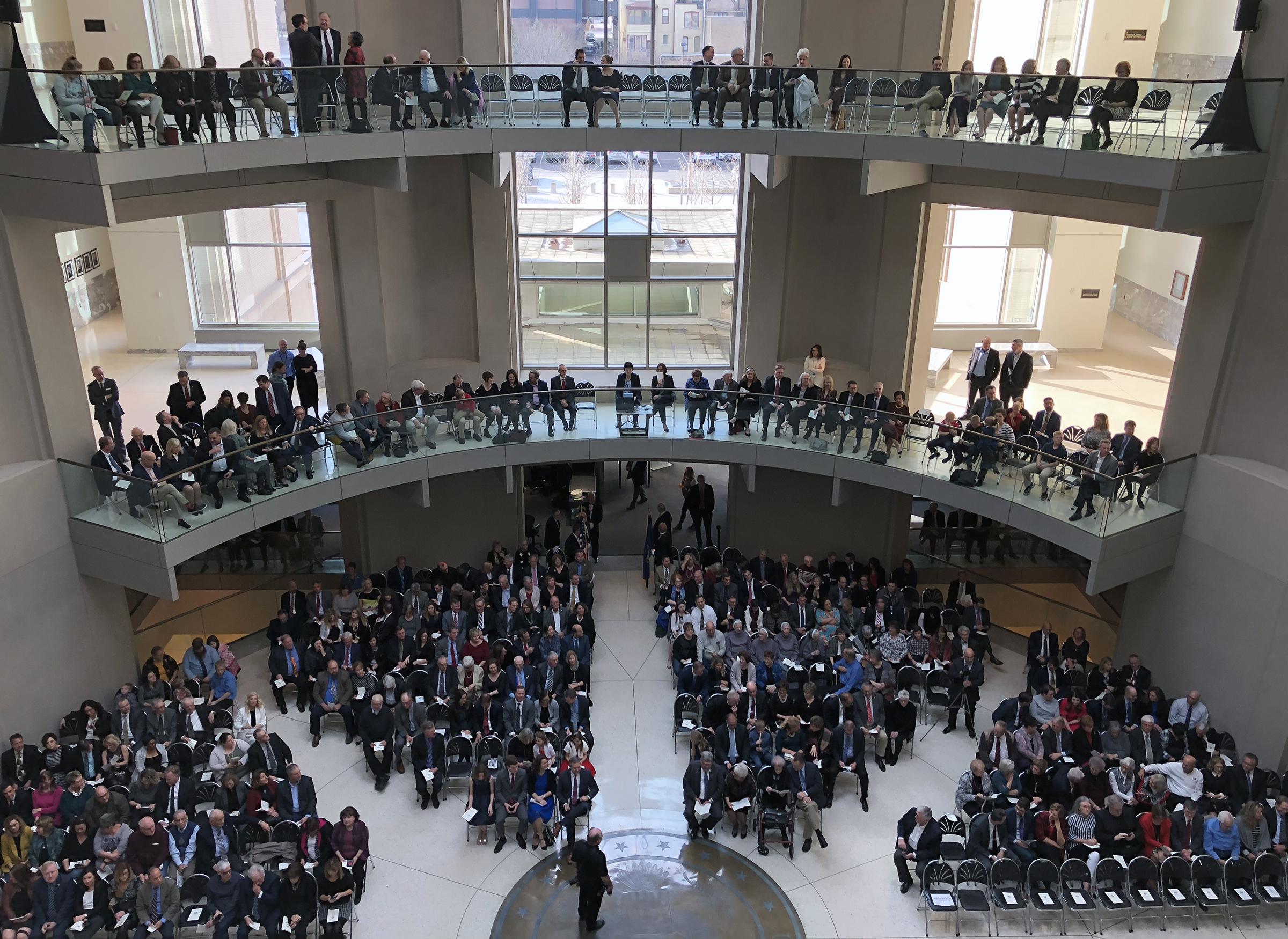 A large crowd filled the Hruska Federal Courthouse atrium, as well as the balconies for three floors above the stage for Brian C. Buescher&#039;s investiture ceremony on Friday, Nov. 15, 2019. (Photo by Scott Stewart)