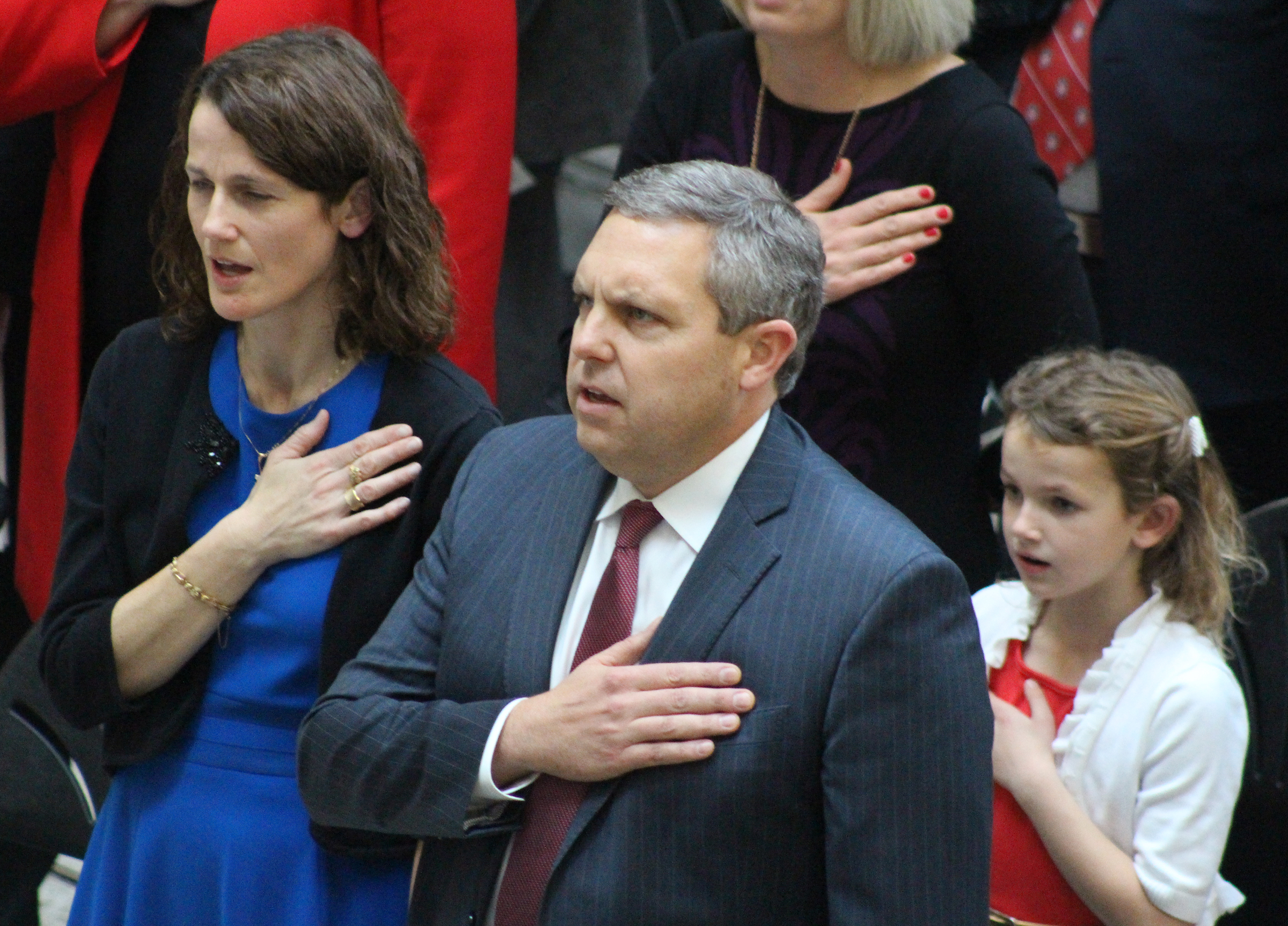 Brian C. Buescher and his family sing the national anthem during his investiture ceremony at the Hruska Federal Courthouse on Friday, Nov. 15, 2019. (Photo by Scott Stewart)