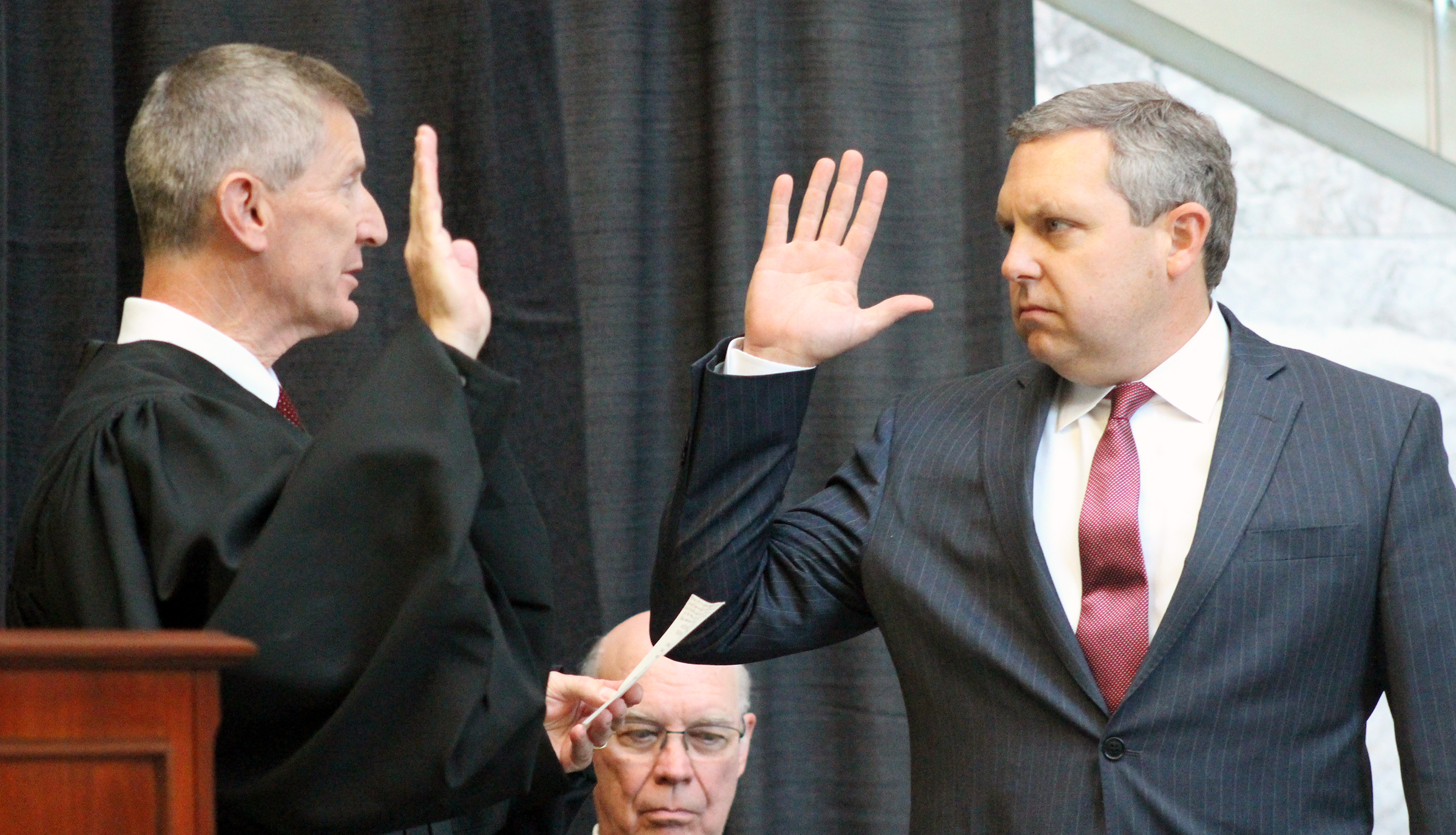 Brian C. Buescher, right, takes the oath of office, administered by Eighth Circuit Appeals Court Judge L. Steven Grasz, left, during his investiture ceremony at the Hruska Federal Courthouse on Friday, Nov. 15, 2019. (Photo by Scott Stewart)