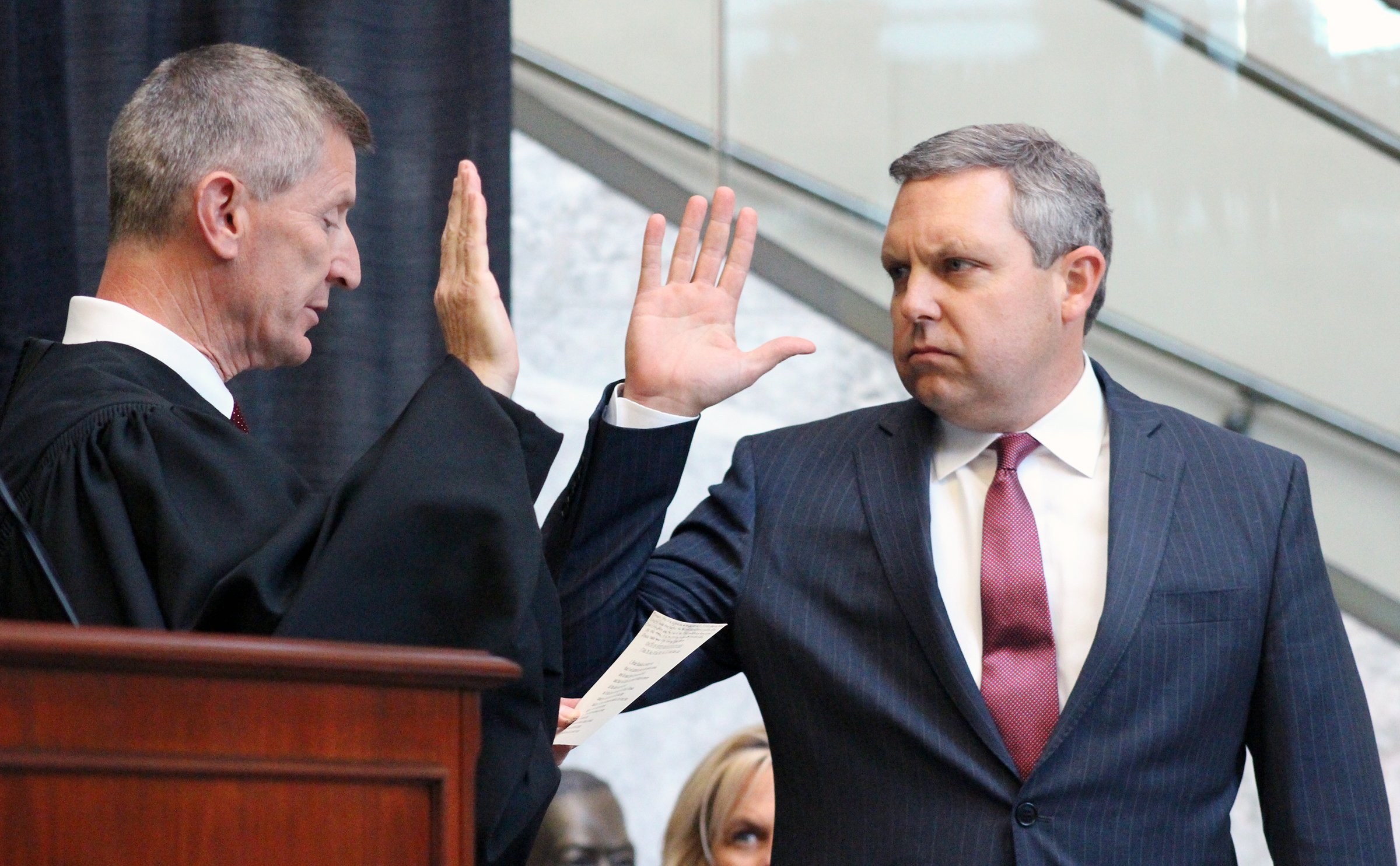 Brian C. Buescher, right, takes the oath of office, administered by Eighth Circuit Appeals Court Judge L. Steven Grasz, left, during his investiture ceremony at the Hruska Federal Courthouse on Friday, Nov. 15, 2019. (Photo by Scott Stewart)