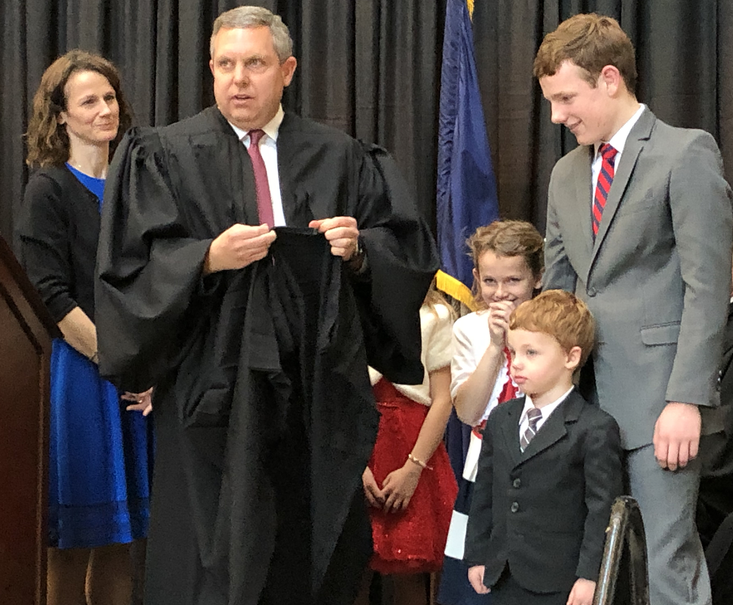 Brian C. Buescher dons his black robes with the help of his family during his investiture ceremony at the Hruska Federal Courthouse on Friday, Nov. 15, 2019. (Photo by Scott Stewart)